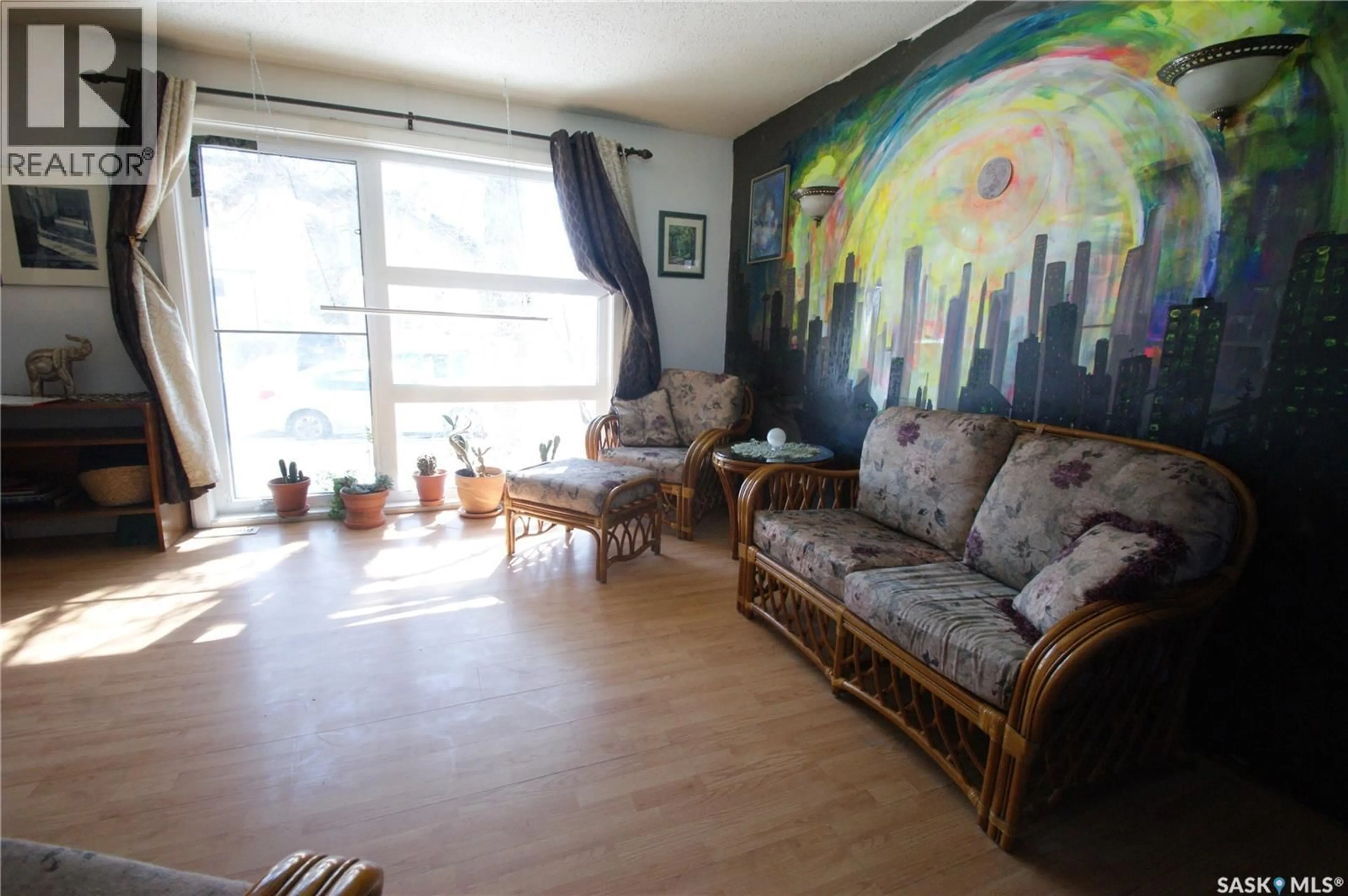 Living room with furniture, wood/laminate floor for 119 RAMSAY COURT, Saskatoon Saskatchewan S7H4H3