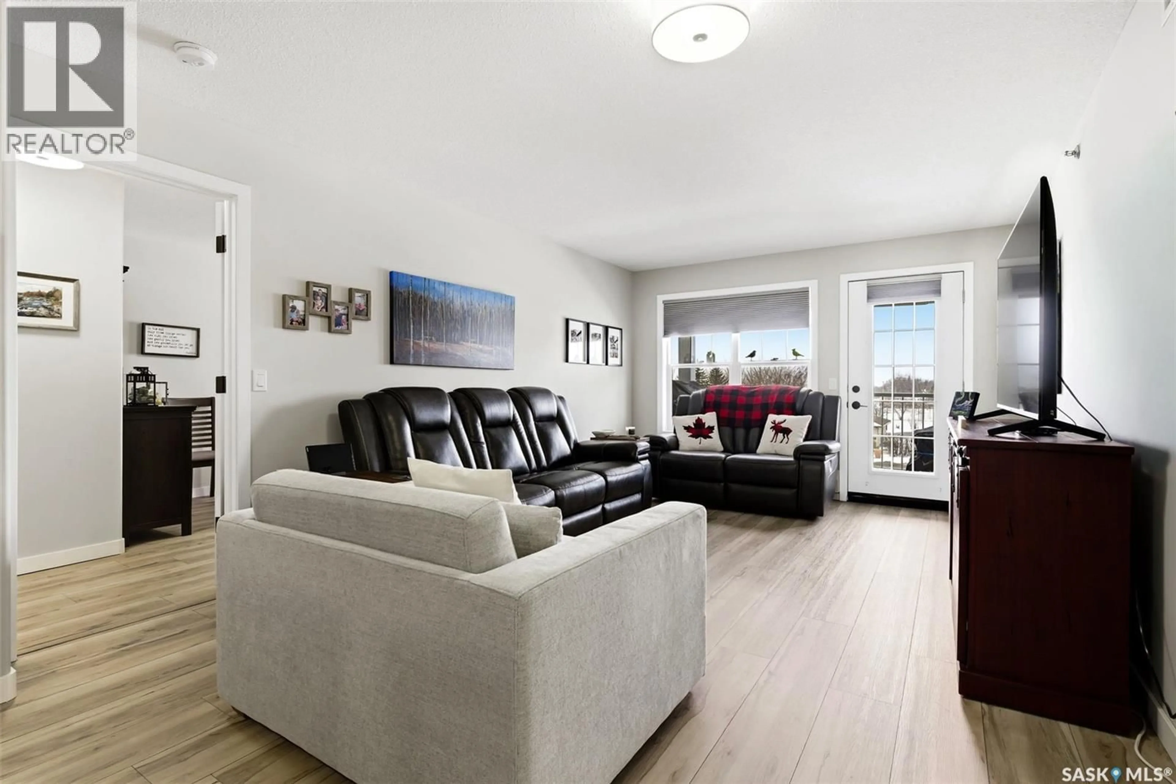 Living room with furniture, wood/laminate floor for 303 100 5TH AVENUE, Regina Beach Saskatchewan S0G4C0