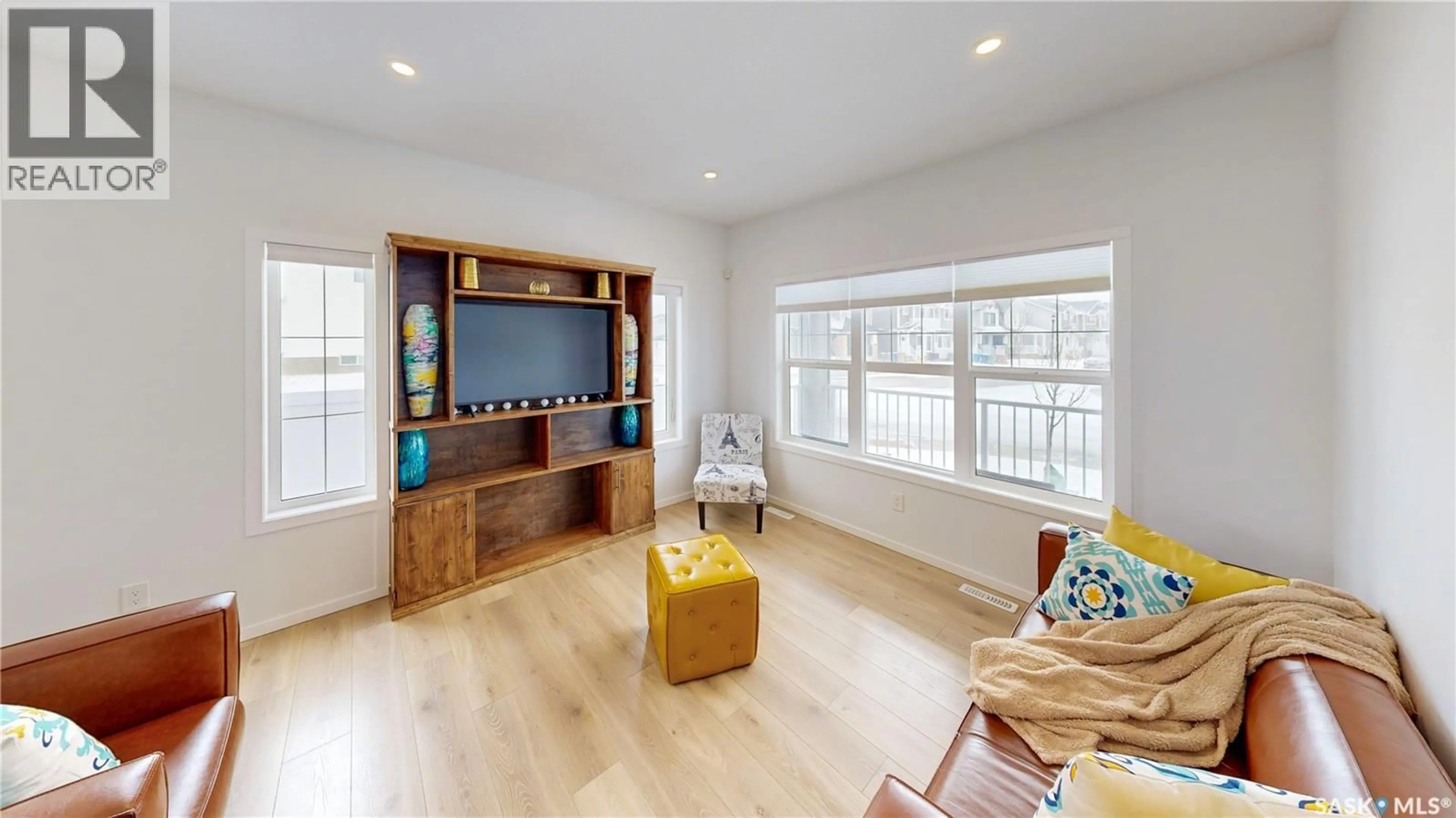 Living room with furniture, wood/laminate floor for 3100 CROSBIE CRESCENT, Regina Saskatchewan S4V3S2