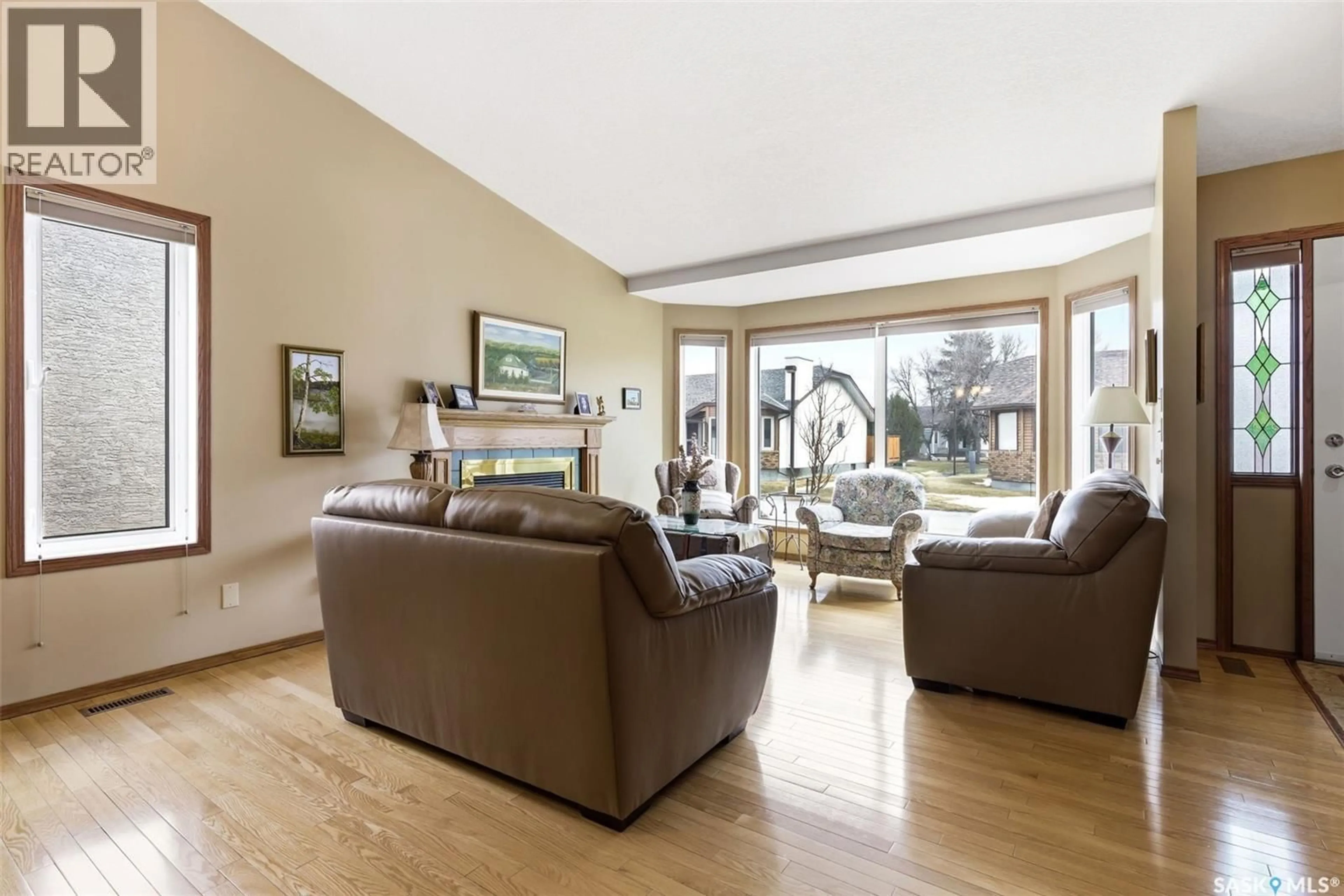 Living room with furniture, wood/laminate floor for 72 GREENSBORO DRIVE, Regina Saskatchewan S4S7G1