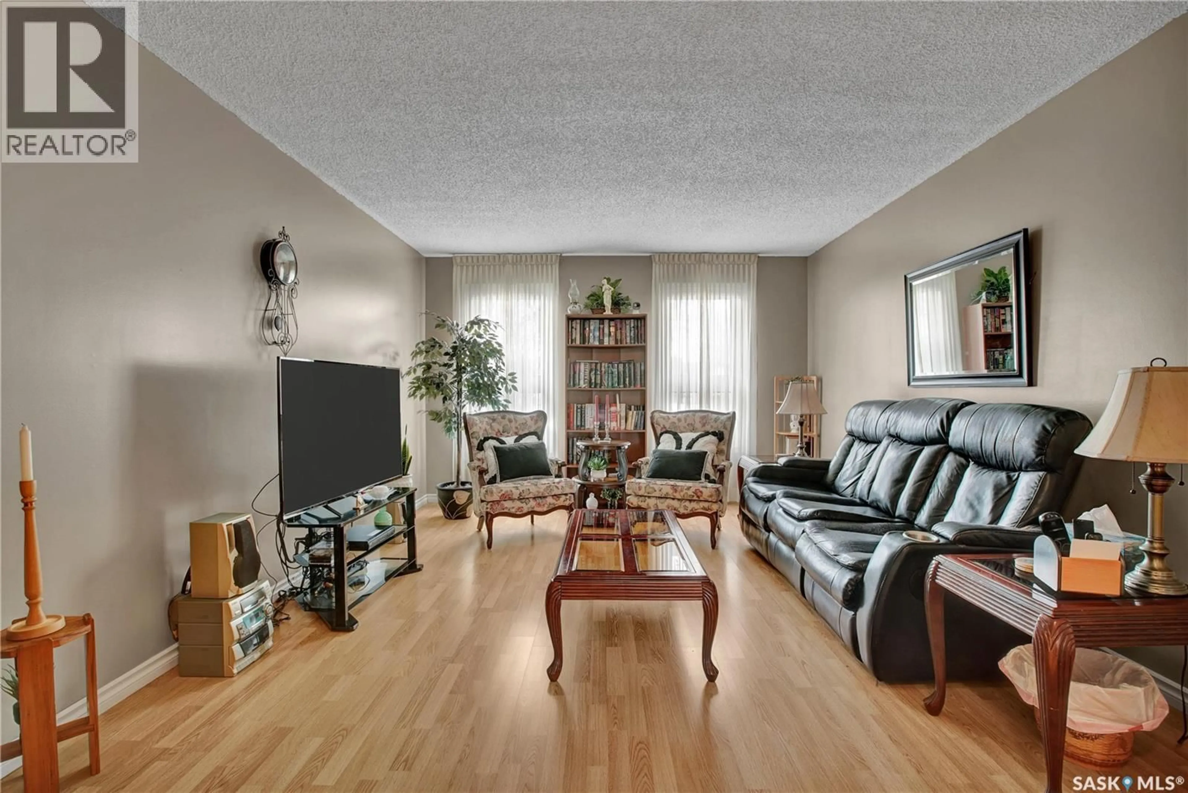 Living room with furniture, wood/laminate floor for 221 LANE COURT, Warman Saskatchewan S0K4S0