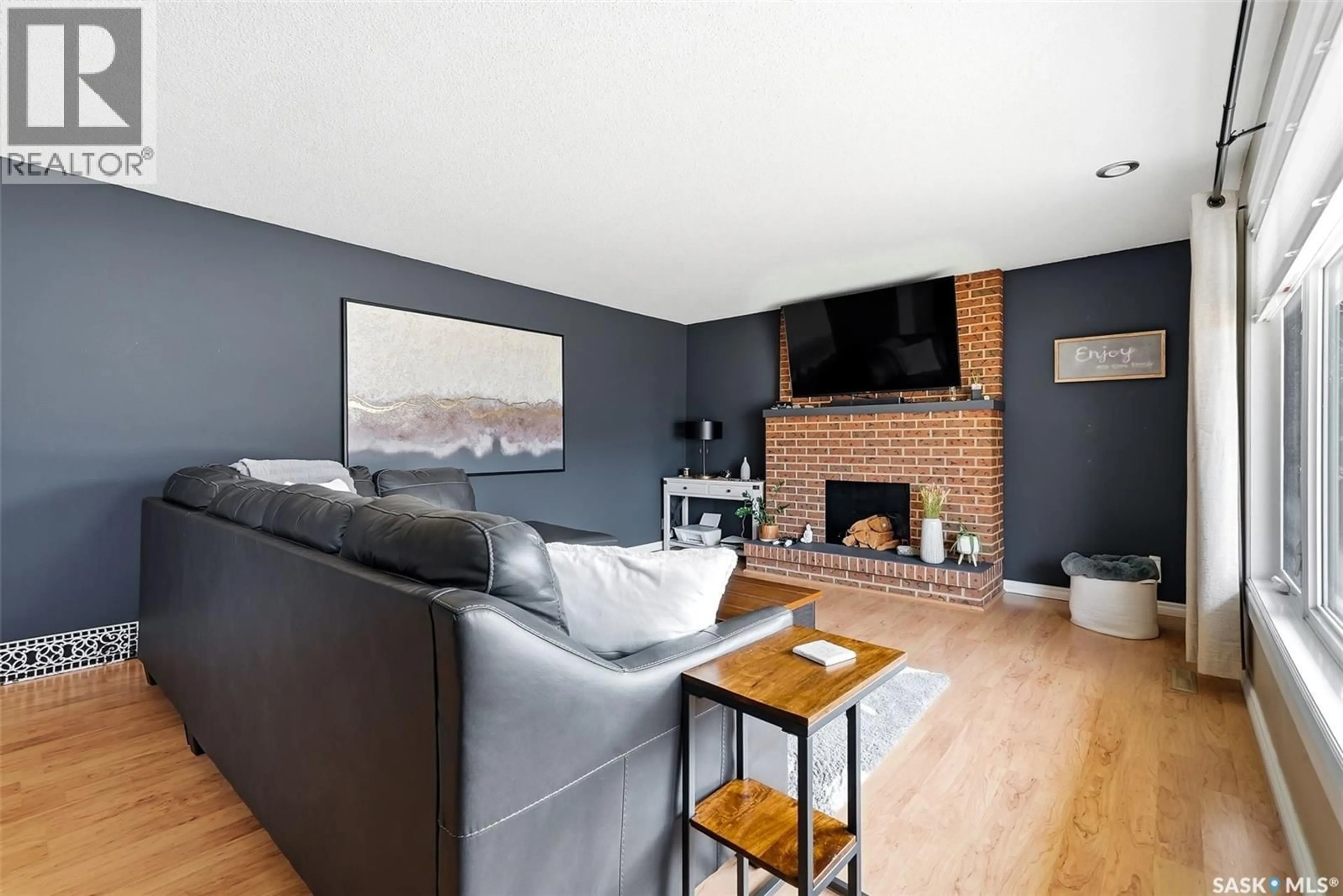 Living room with furniture, wood/laminate floor for 504 11TH STREET, Weyburn Saskatchewan S4H1J9