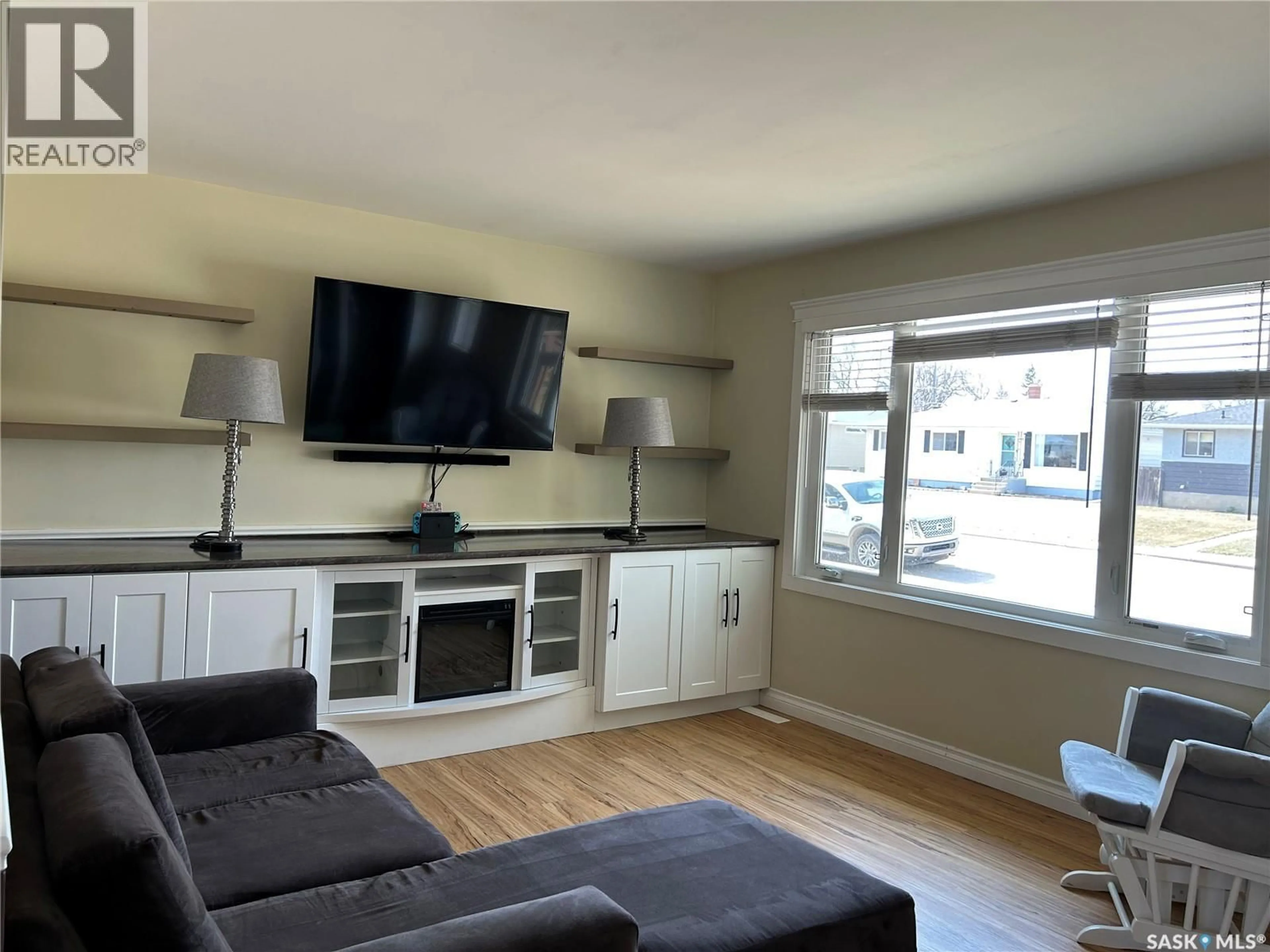 Living room with furniture, wood/laminate floor for 125 4TH AVENUE, Swift Current Saskatchewan S9H3L3