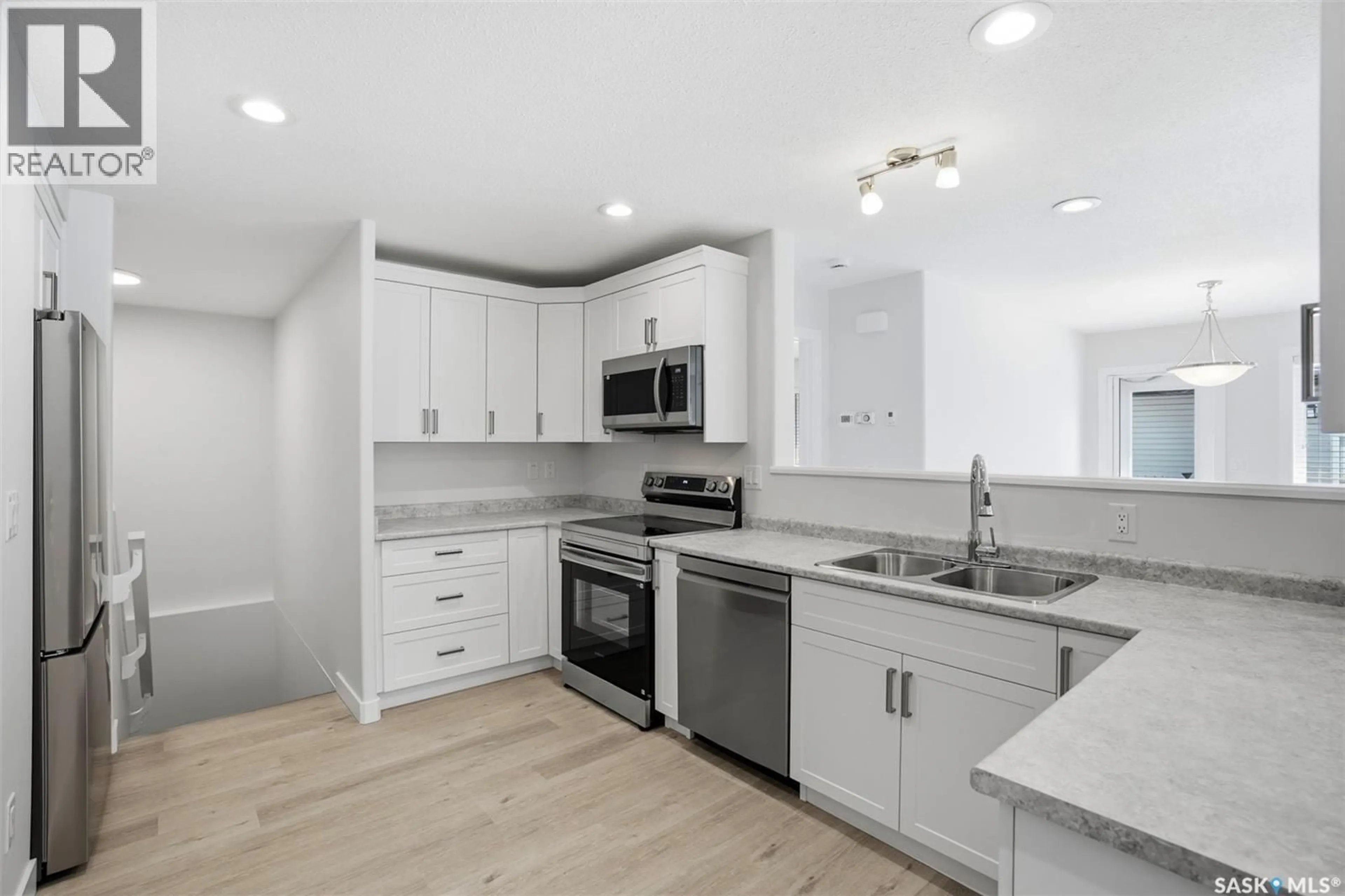 Open concept kitchen, ceramic/tile floor for 27 547 EAST HAMPTON BOULEVARD, Saskatoon Saskatchewan S7R0H8