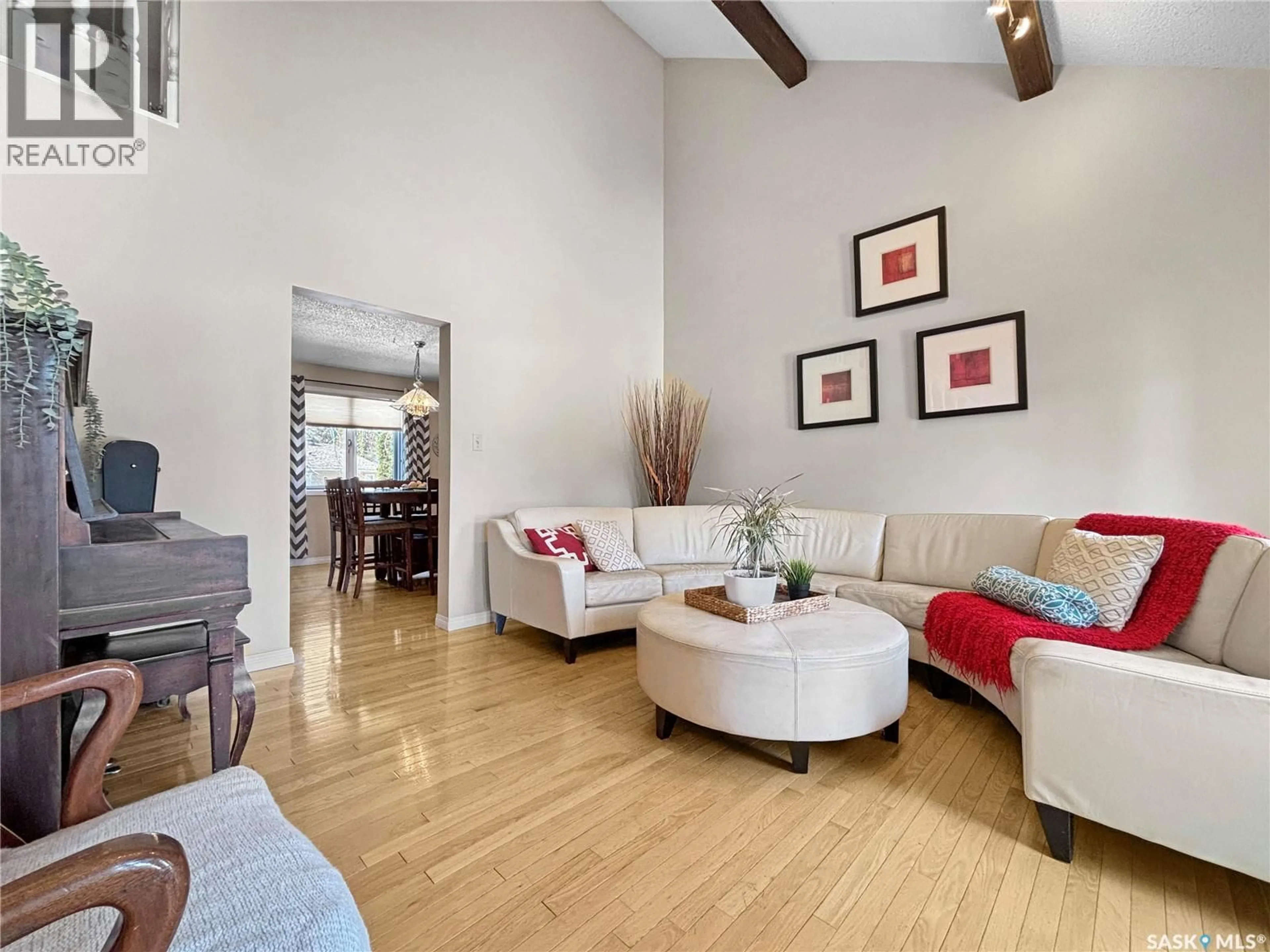 Living room with furniture, wood/laminate floor for 302 NOKOMIS PLACE, Saskatoon Saskatchewan S7K5E2