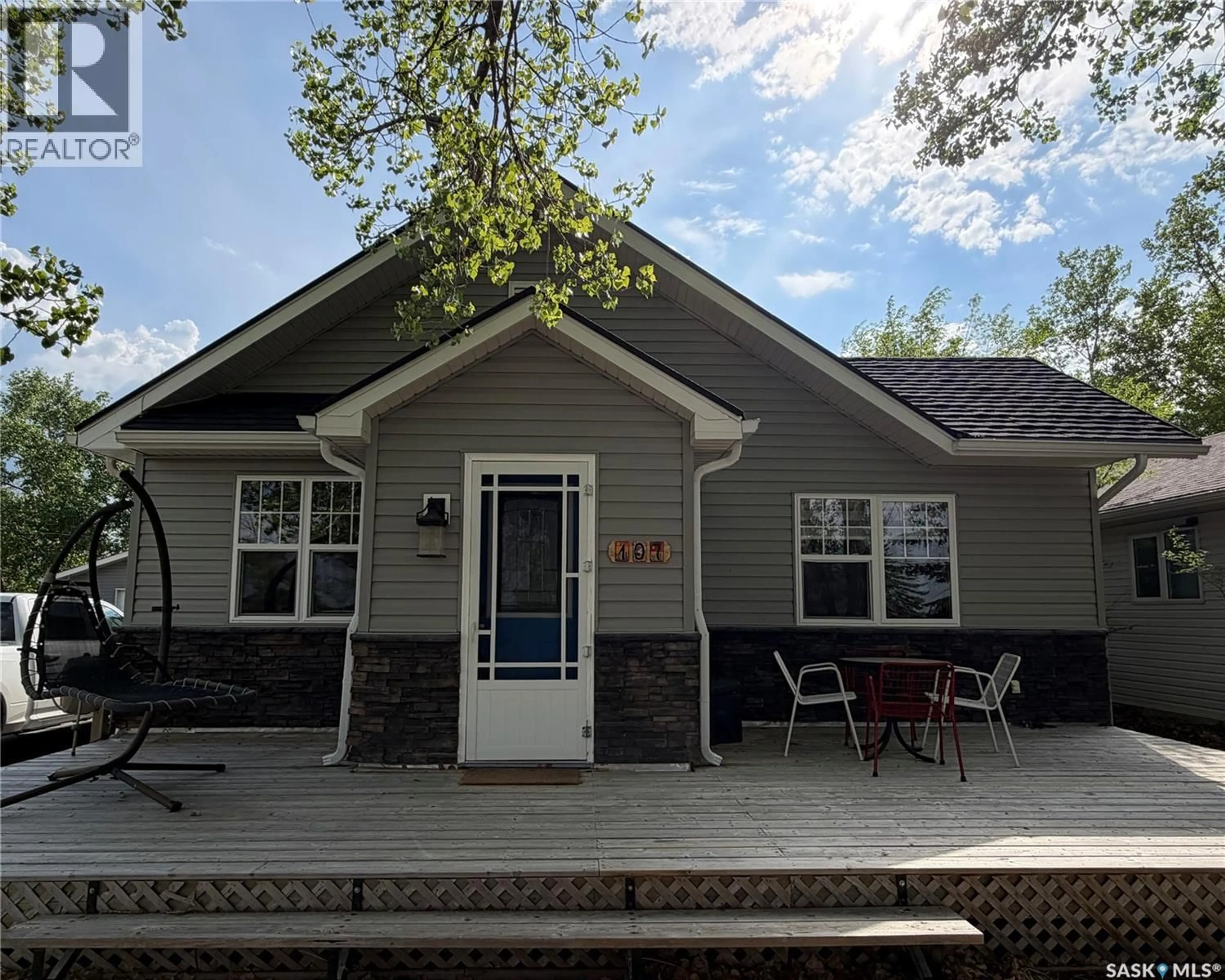 Home with vinyl exterior material, street for 107 MISTUSINNE STREET, Mistusinne Saskatchewan S0H1J0