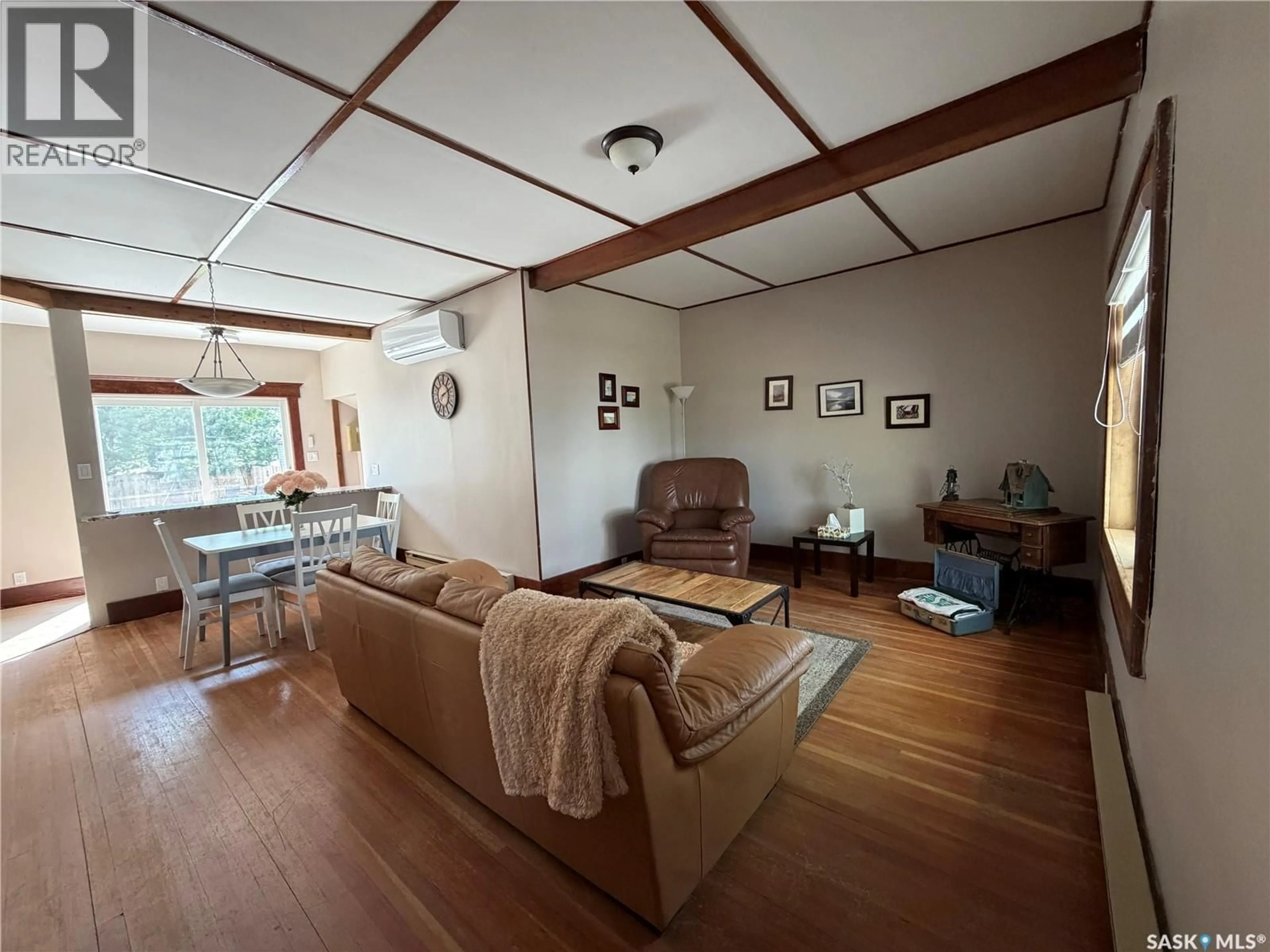 Living room with furniture, wood/laminate floor for 107 MISTUSINNE STREET, Mistusinne Saskatchewan S0H1J0