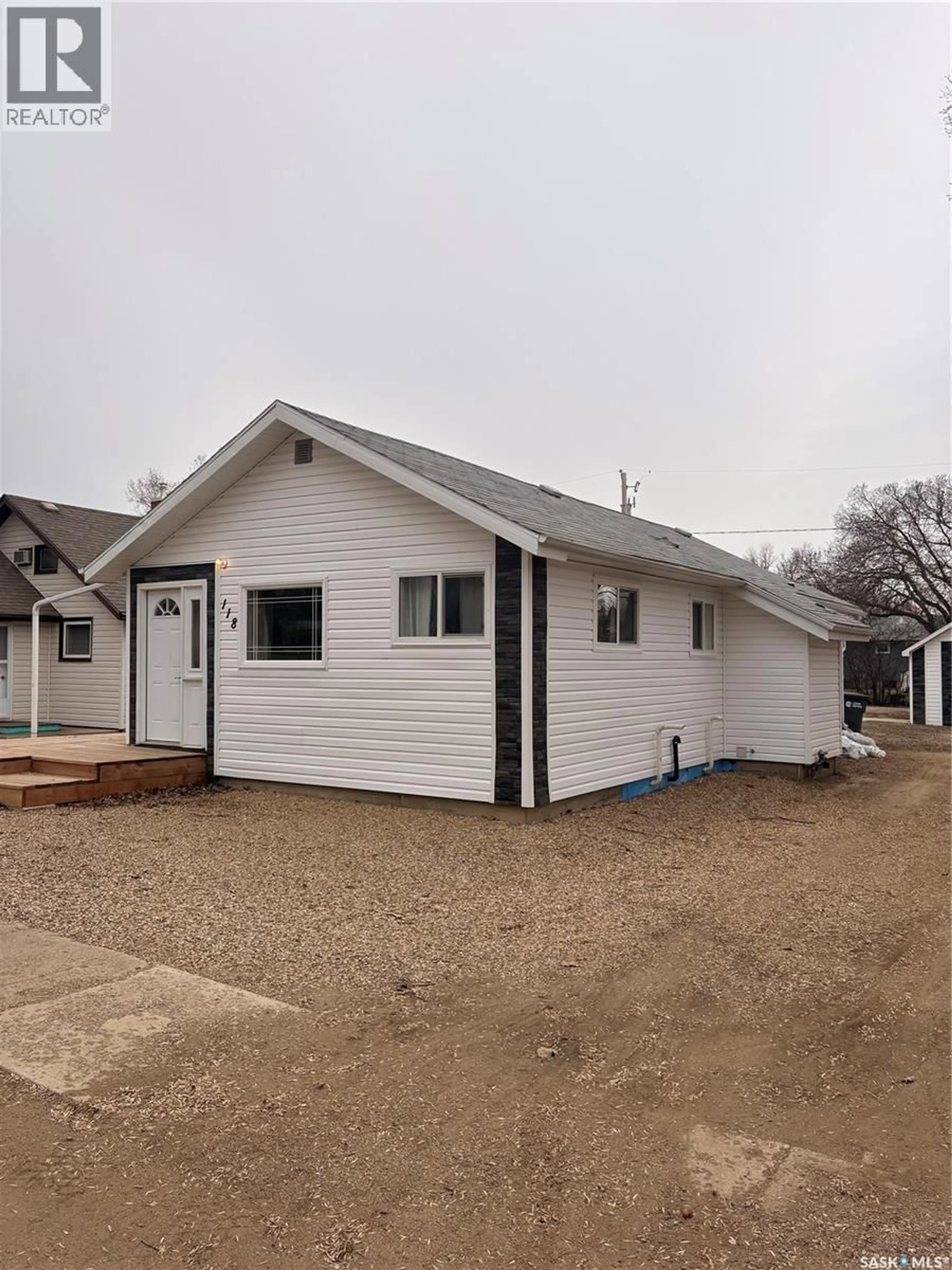 Home with vinyl exterior material, street for 118 2ND STREET, Lafleche Saskatchewan S0H2K0