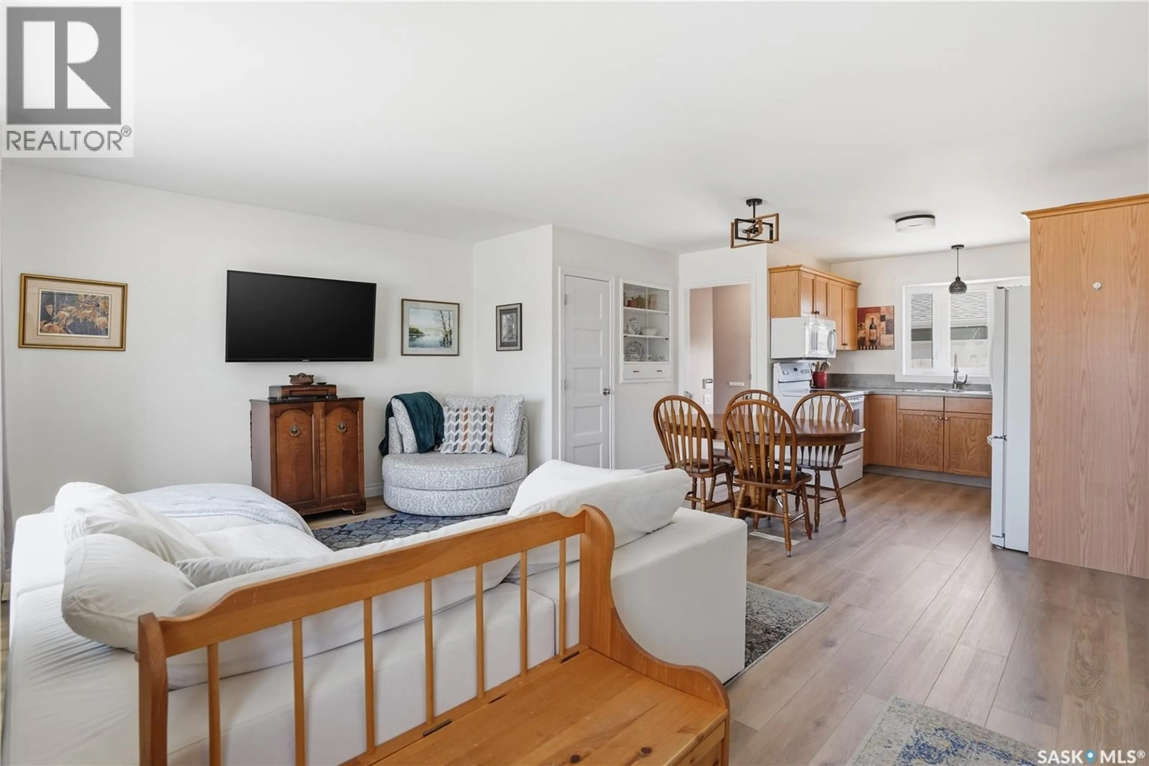 Living room with furniture, wood/laminate floor for 23 ARMOUR STREET, Regina Saskatchewan S4R4G4