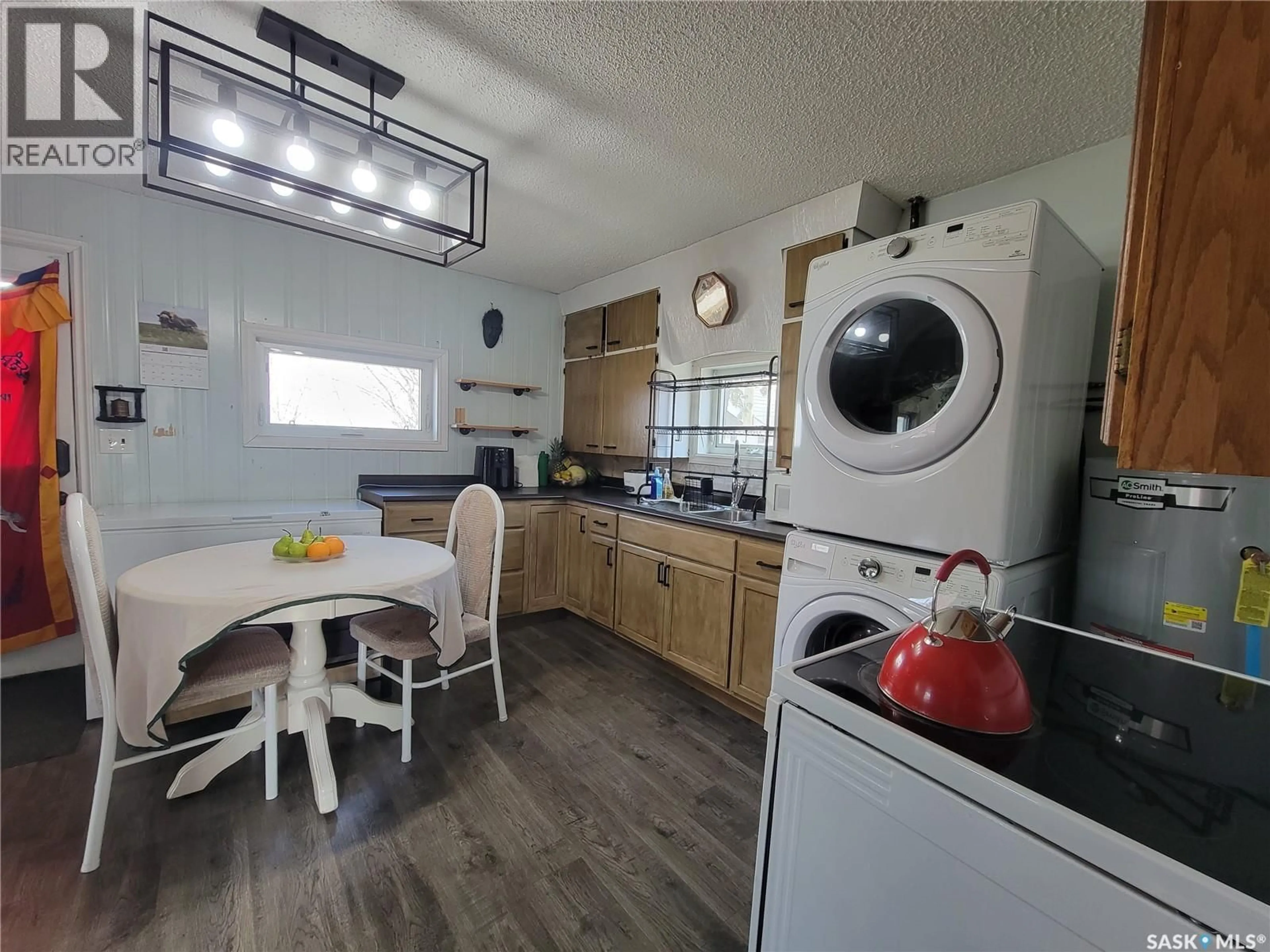 Kitchen with laundary machines, wood/laminate floor for 304 1ST AVENUE, Maidstone Saskatchewan S0M1M0