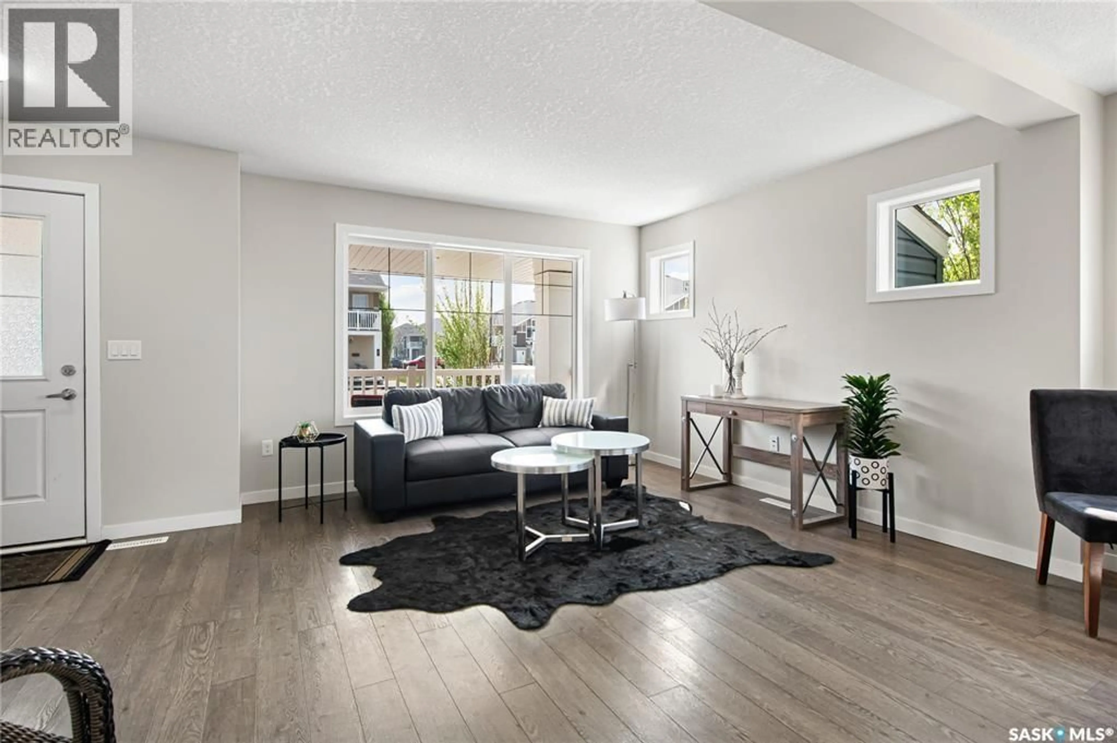 Living room with furniture, wood/laminate floor for 14 - 5762 GORDON ROAD, Regina Saskatchewan S4W0M1