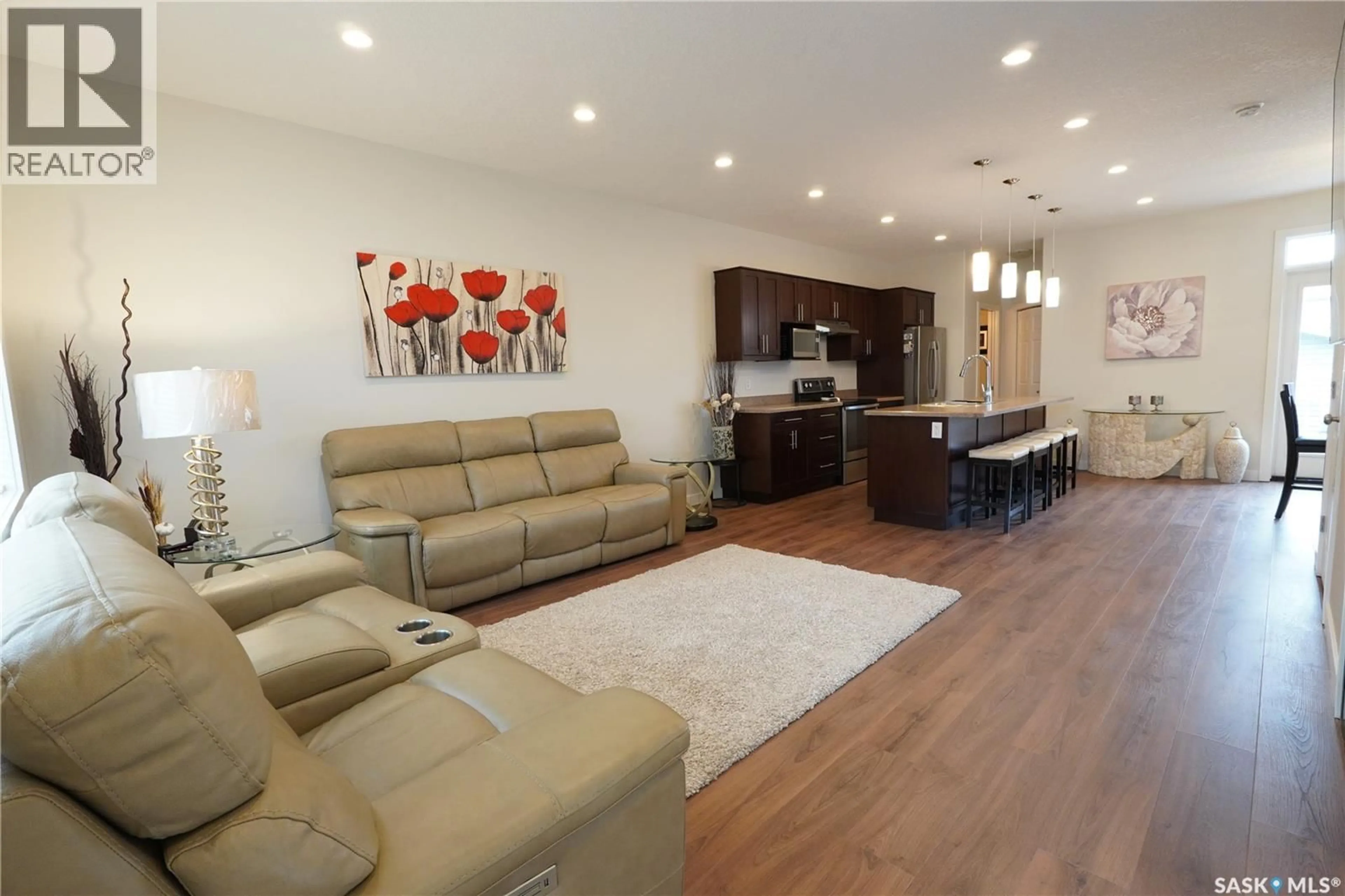 Living room with furniture, wood/laminate floor for E - 4125 GREEN OLIVE WAY, Regina Saskatchewan S4V1P8