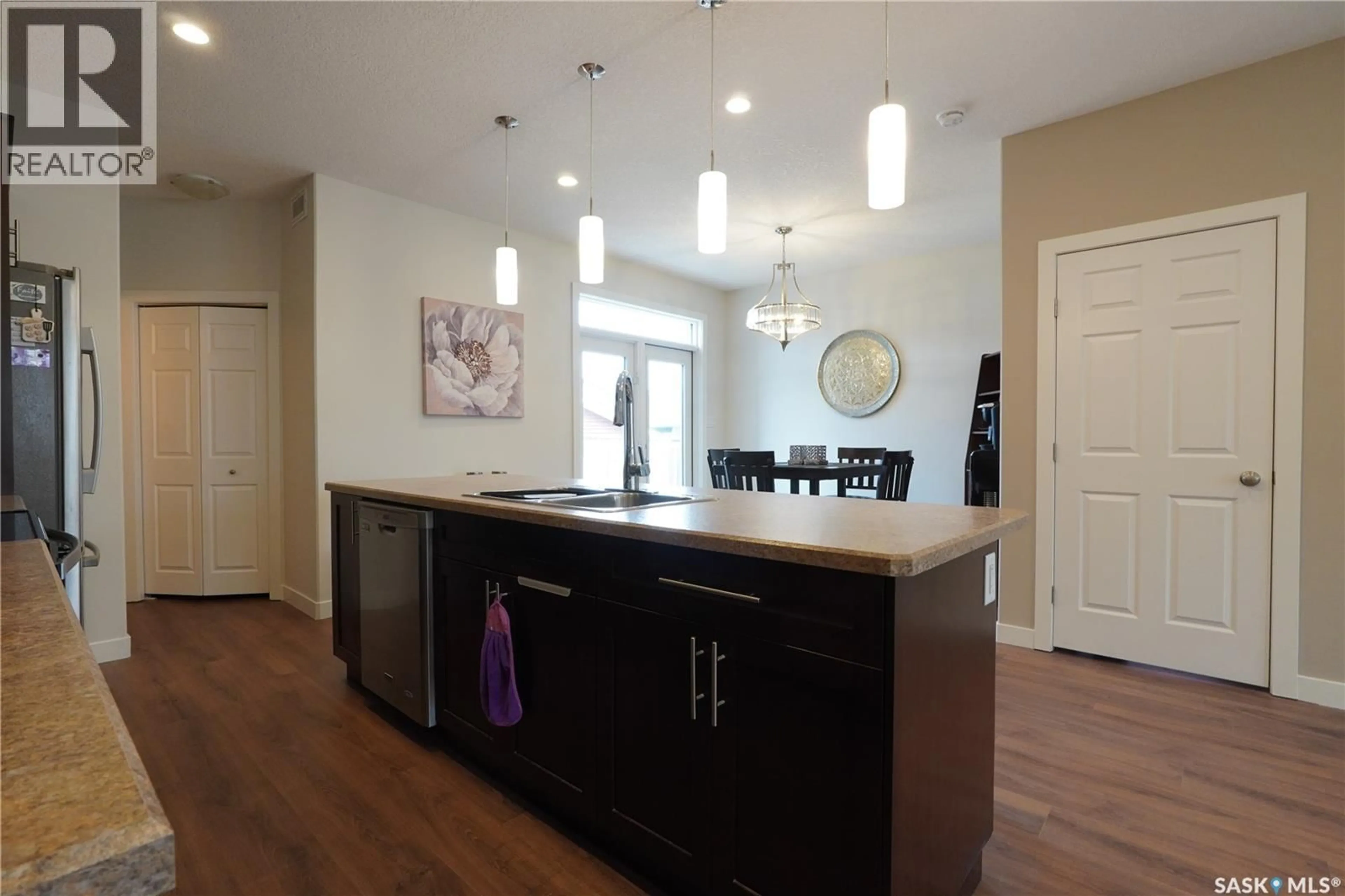 Open concept kitchen, wood/laminate floor for E - 4125 GREEN OLIVE WAY, Regina Saskatchewan S4V1P8