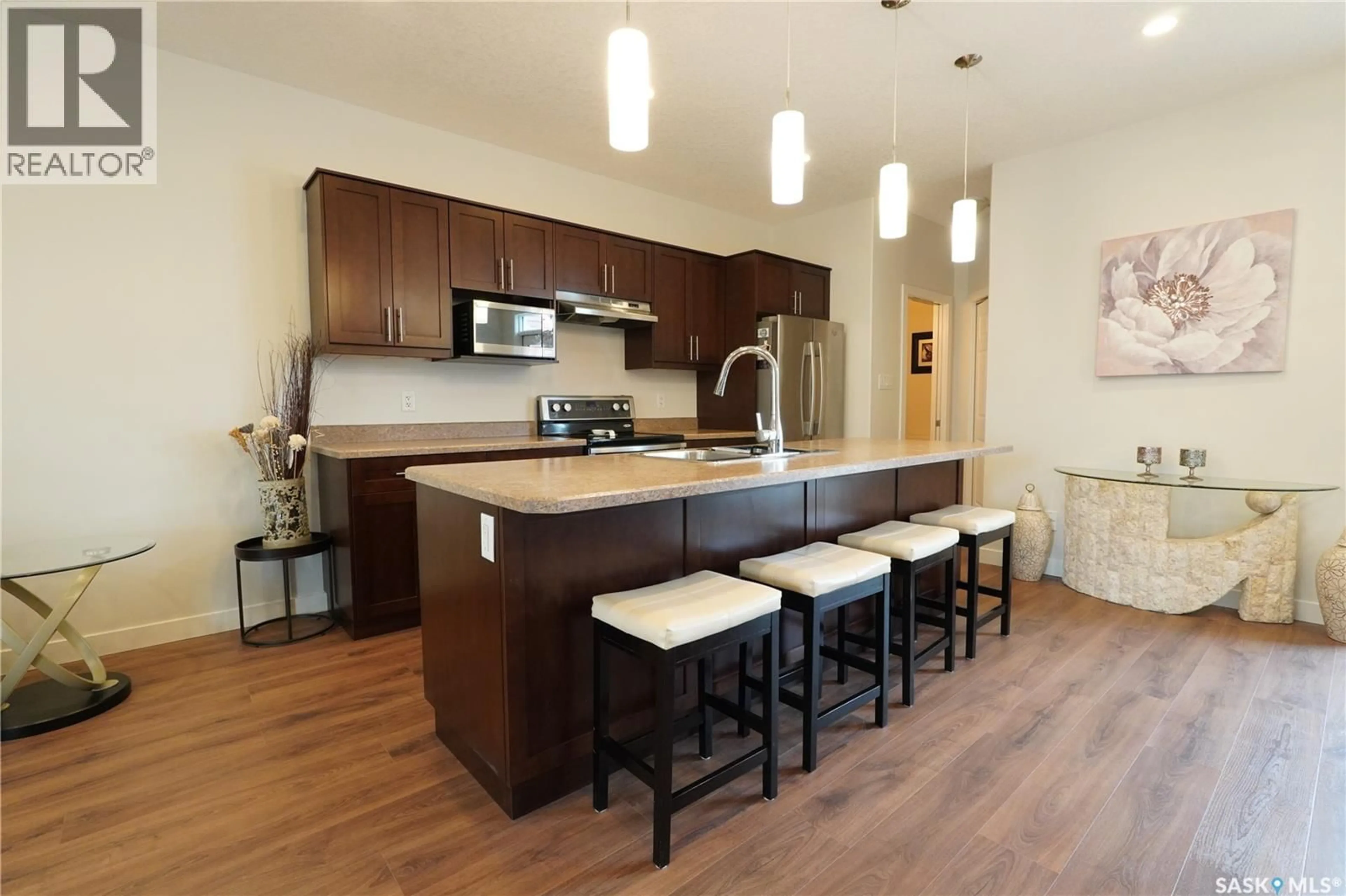 Open concept kitchen, wood/laminate floor for E - 4125 GREEN OLIVE WAY, Regina Saskatchewan S4V1P8