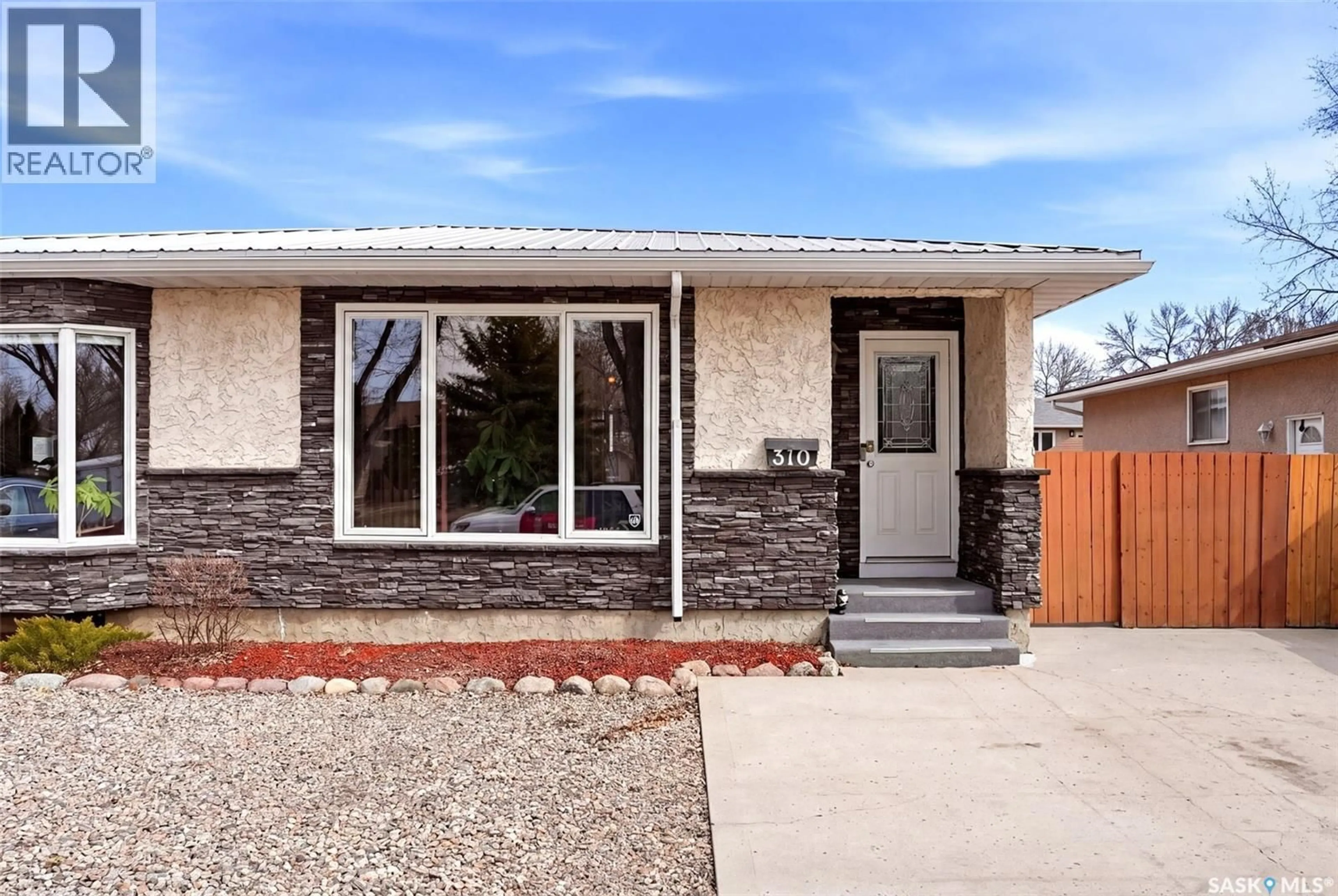 Home with vinyl exterior material, street for 310 MARKWELL DRIVE, Regina Saskatchewan S4X1N1