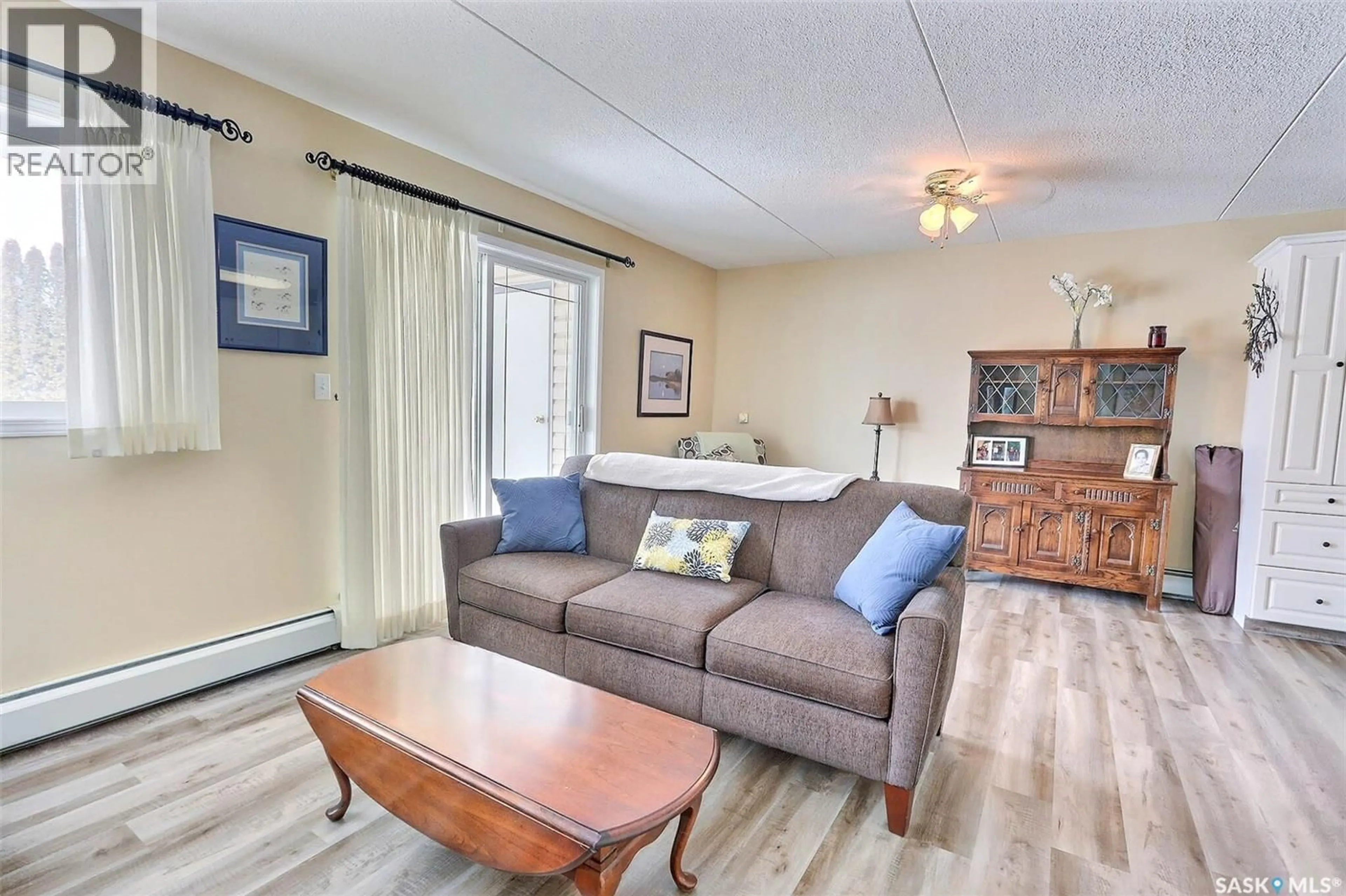 Living room with furniture, wood/laminate floor for E - 201 1 26TH STREET, Prince Albert Saskatchewan S6V1T7