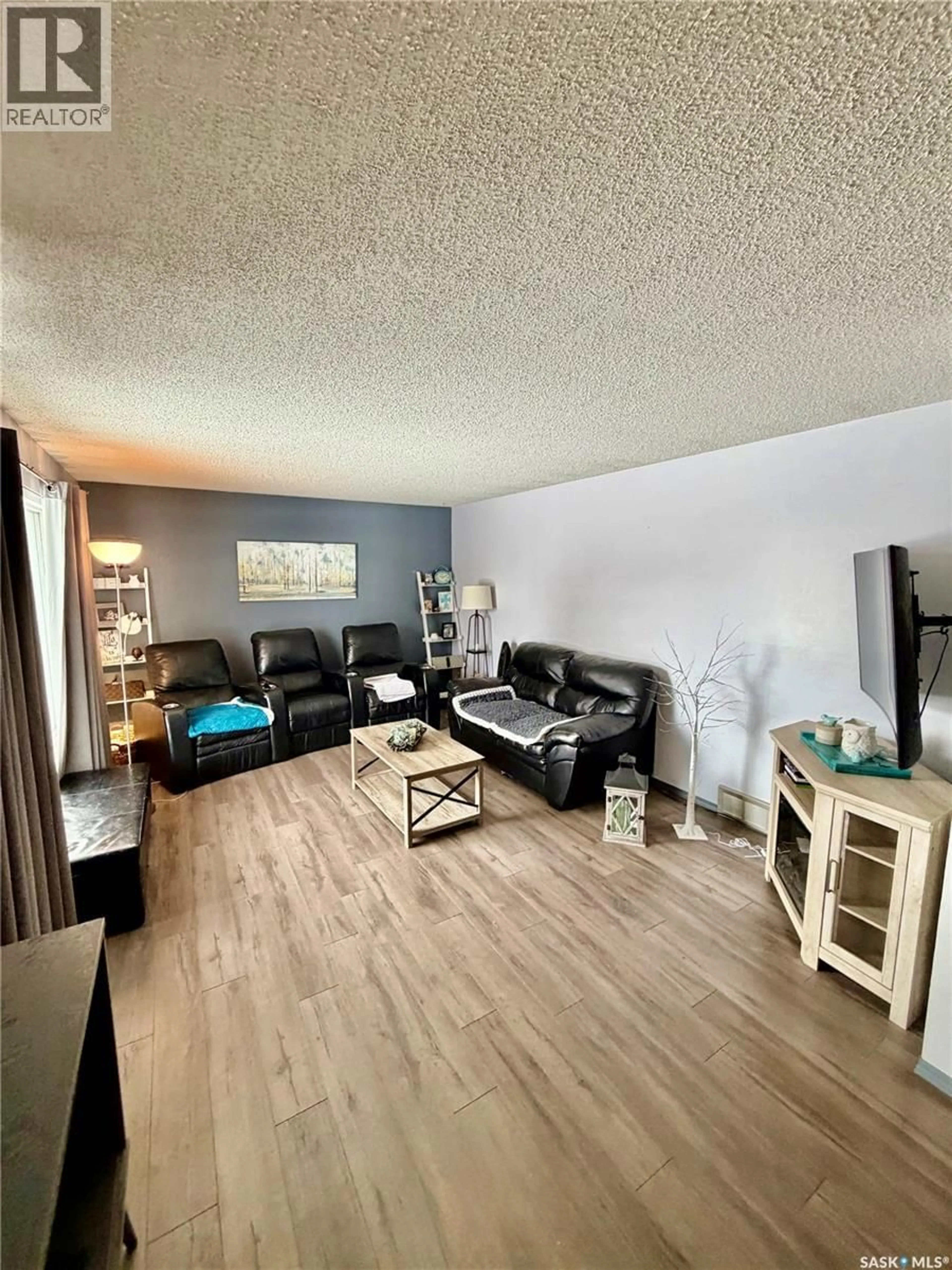 Living room with furniture, wood/laminate floor for 610 MAIN STREET, Hudson Bay Saskatchewan S0E0Y0
