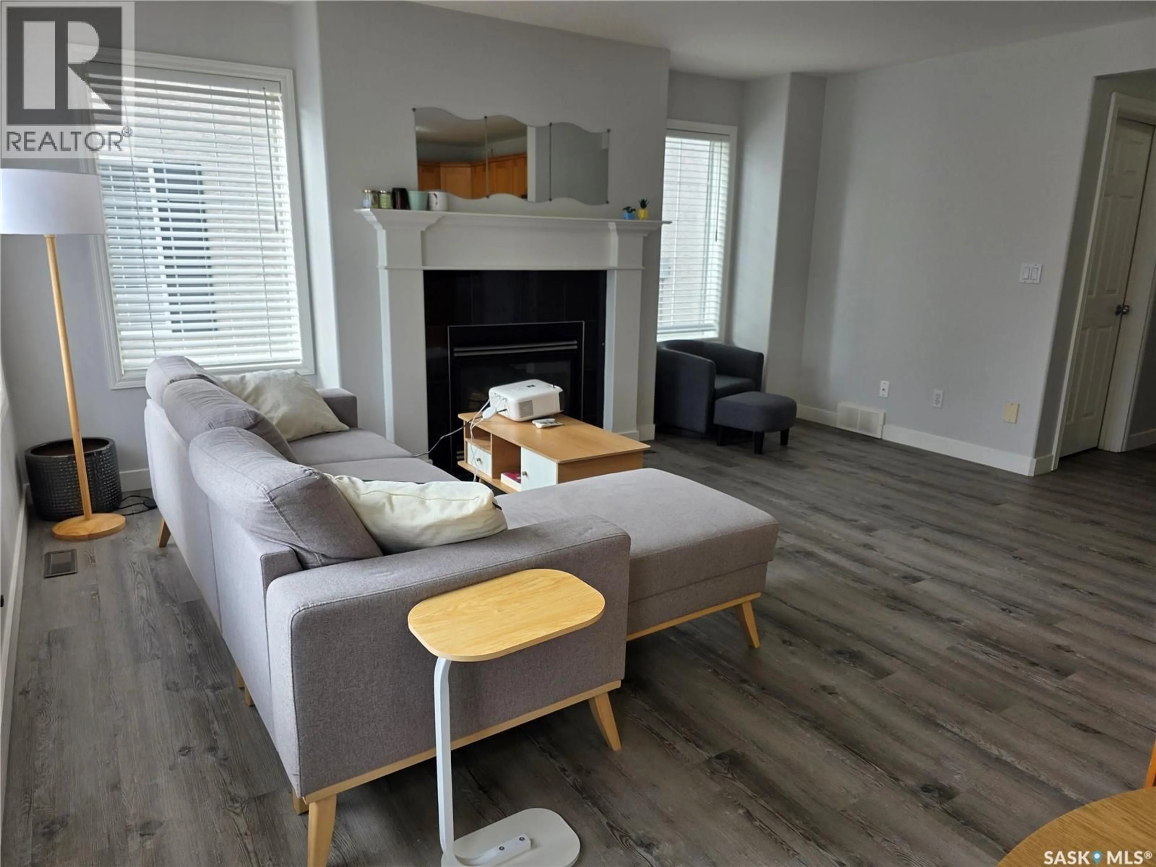 Living room with furniture, wood/laminate floor for 103 - 36 BANYAN CRESCENT, Saskatoon Saskatchewan S7V1G3