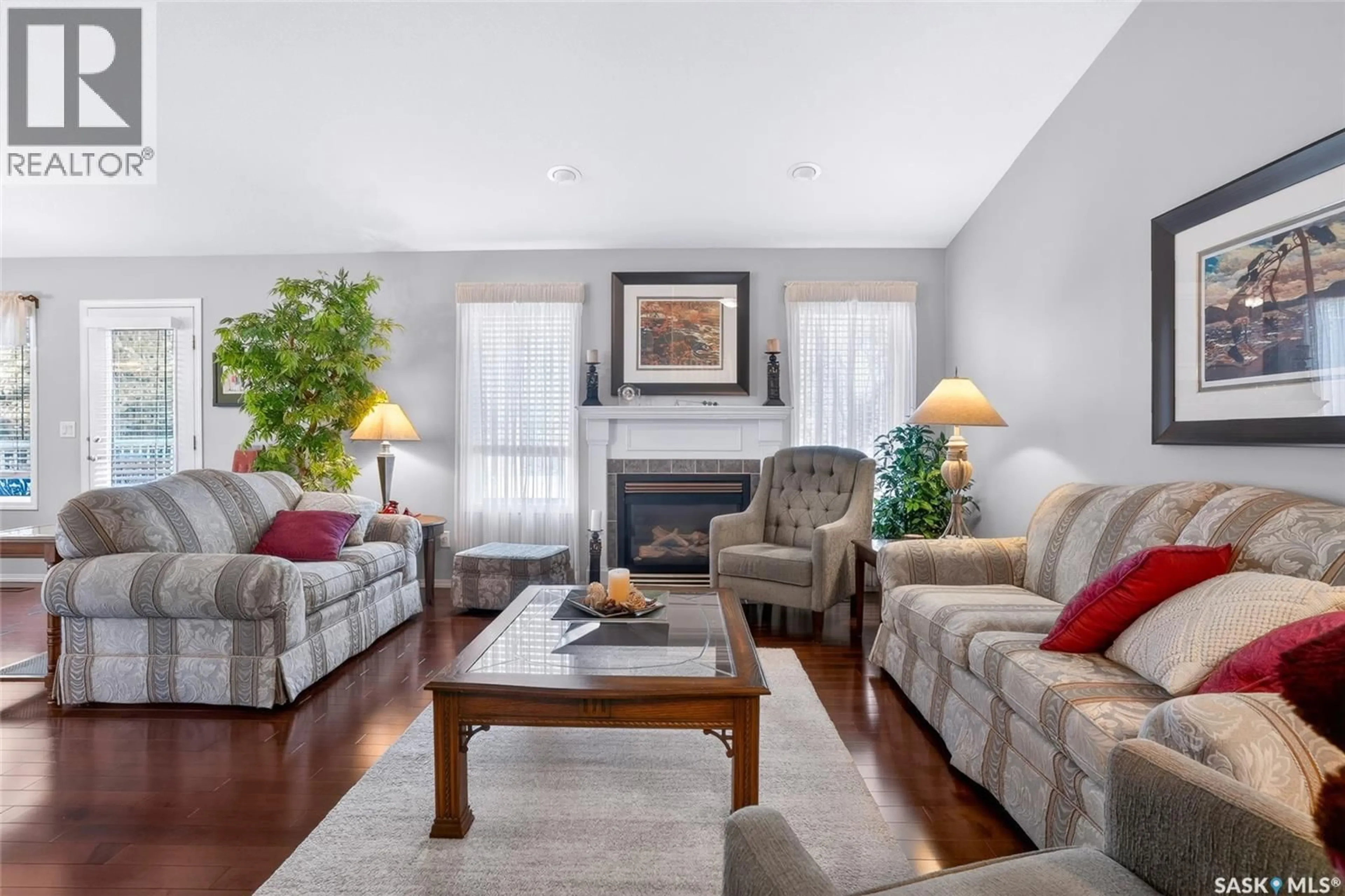 Living room with furniture, wood/laminate floor for 810 - 110 MENDEL CRESCENT, Saskatoon Saskatchewan S7J5K5