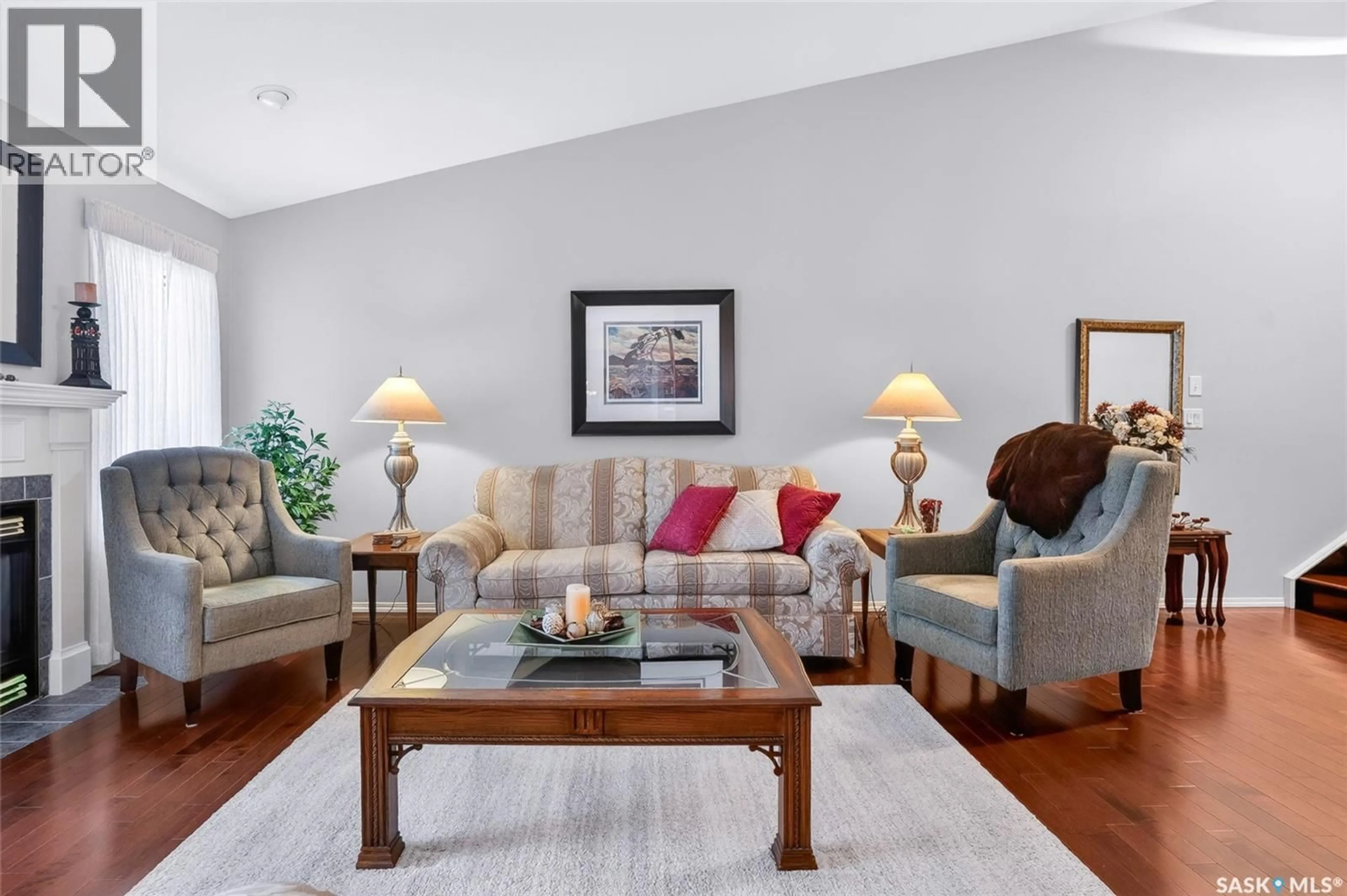 Living room with furniture, wood/laminate floor for 810 - 110 MENDEL CRESCENT, Saskatoon Saskatchewan S7J5K5