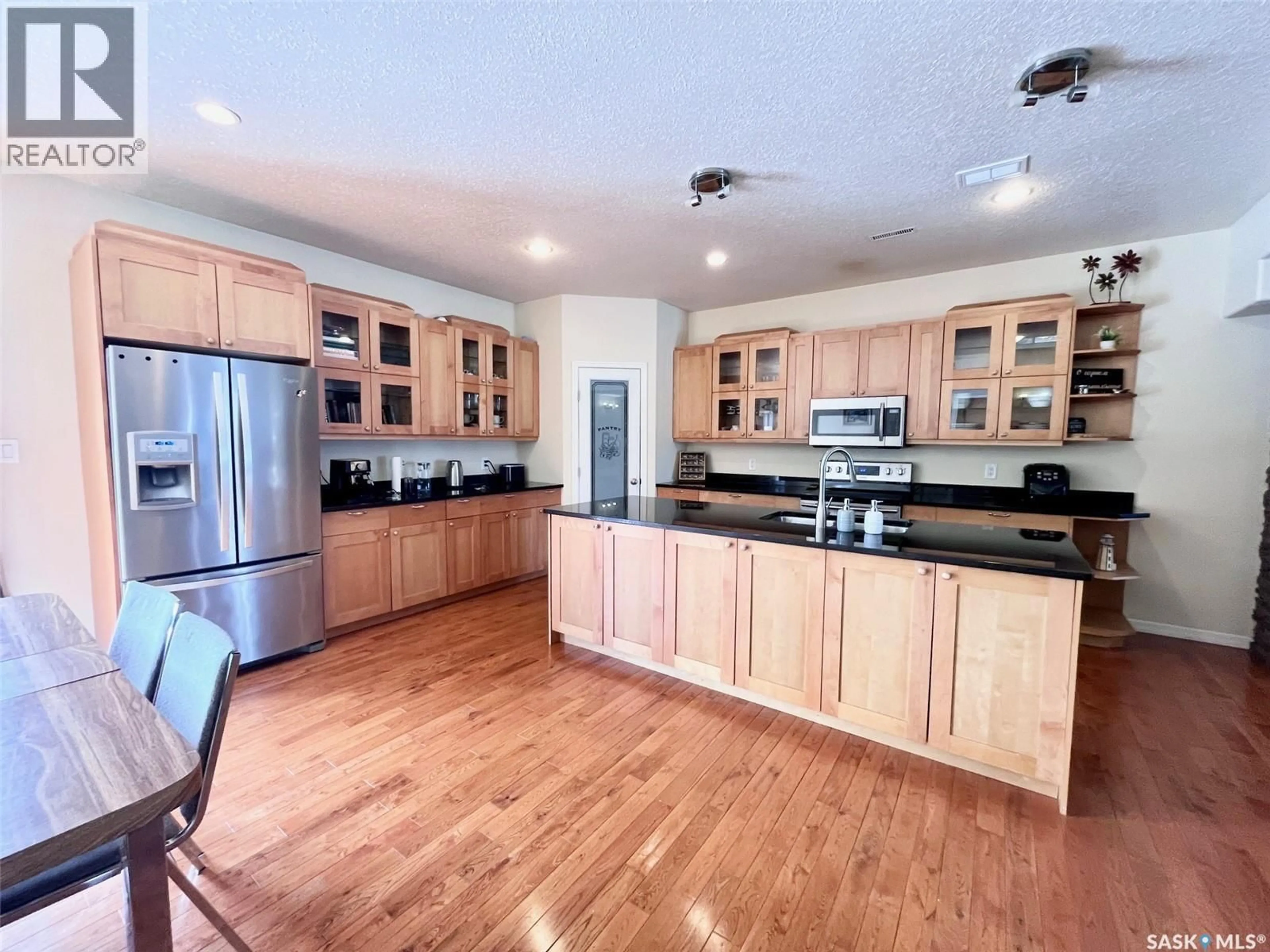 Open concept kitchen, wood/laminate floor for 2 211 20TH STREET, Prince Albert Saskatchewan S6V4G5