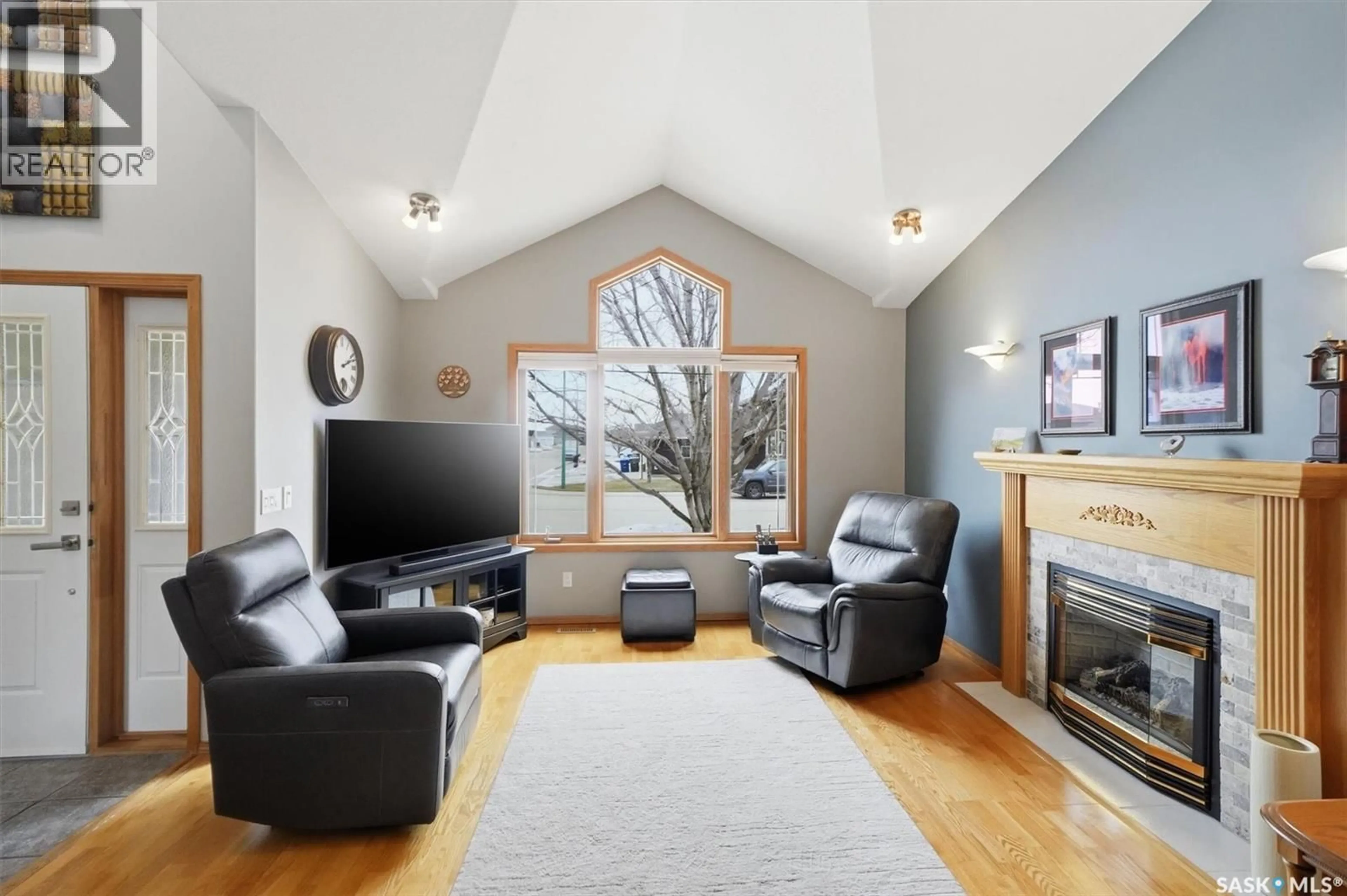 Living room with furniture, wood/laminate floor for 712 SLATER CRESCENT, Martensville Saskatchewan S0K2T0