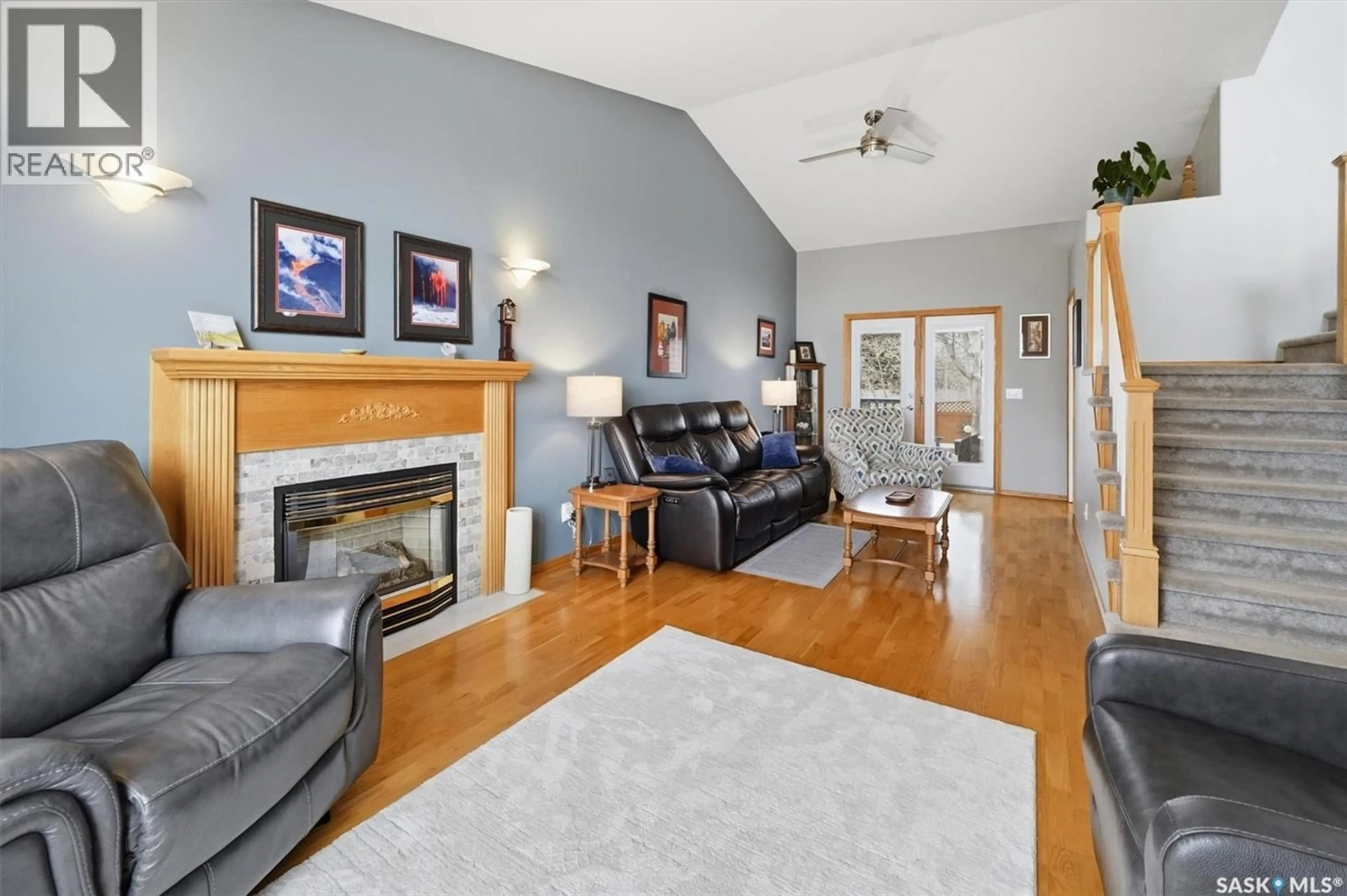 Living room with furniture, wood/laminate floor for 712 SLATER CRESCENT, Martensville Saskatchewan S0K2T0