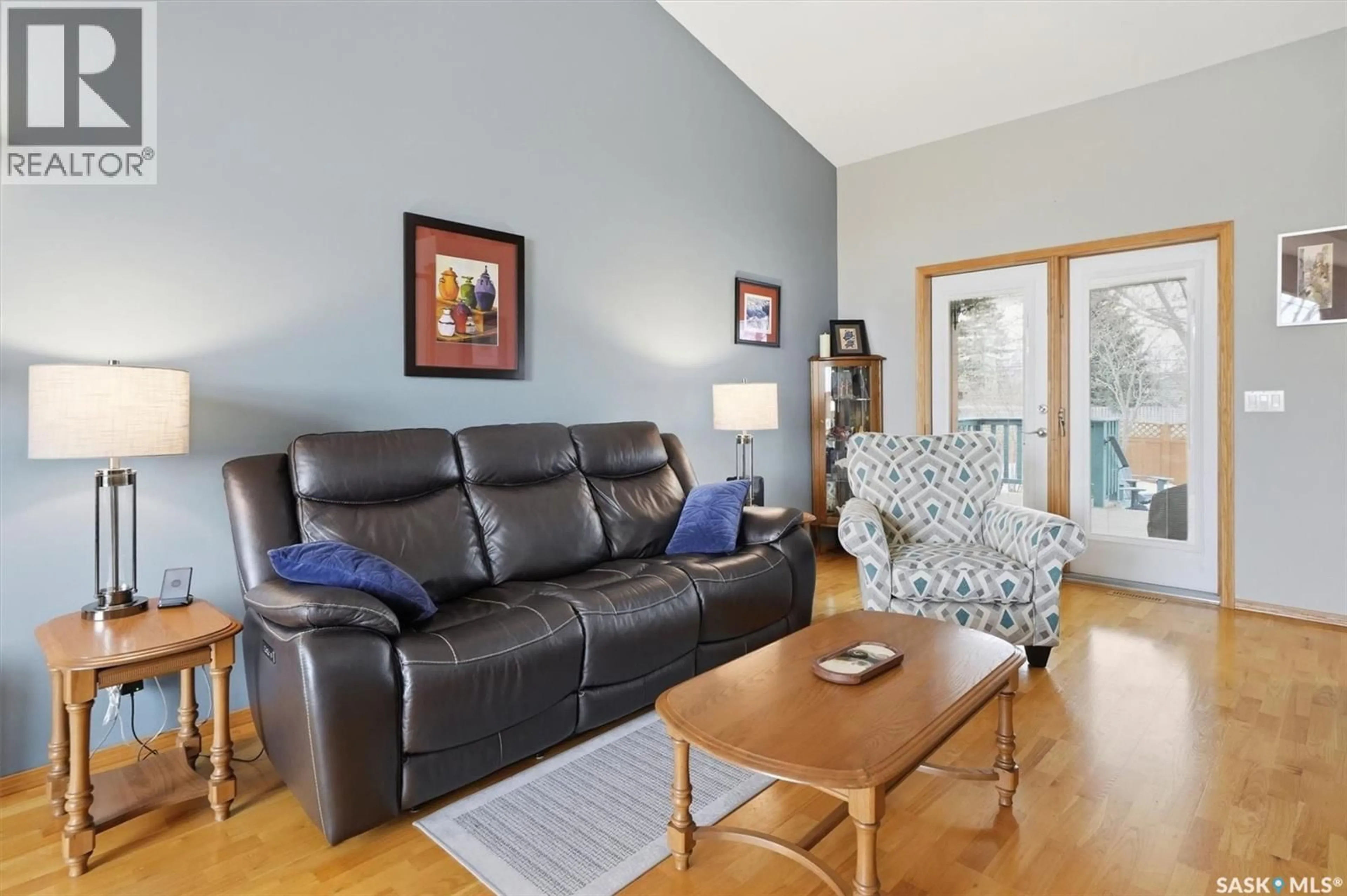 Living room with furniture, wood/laminate floor for 712 SLATER CRESCENT, Martensville Saskatchewan S0K2T0