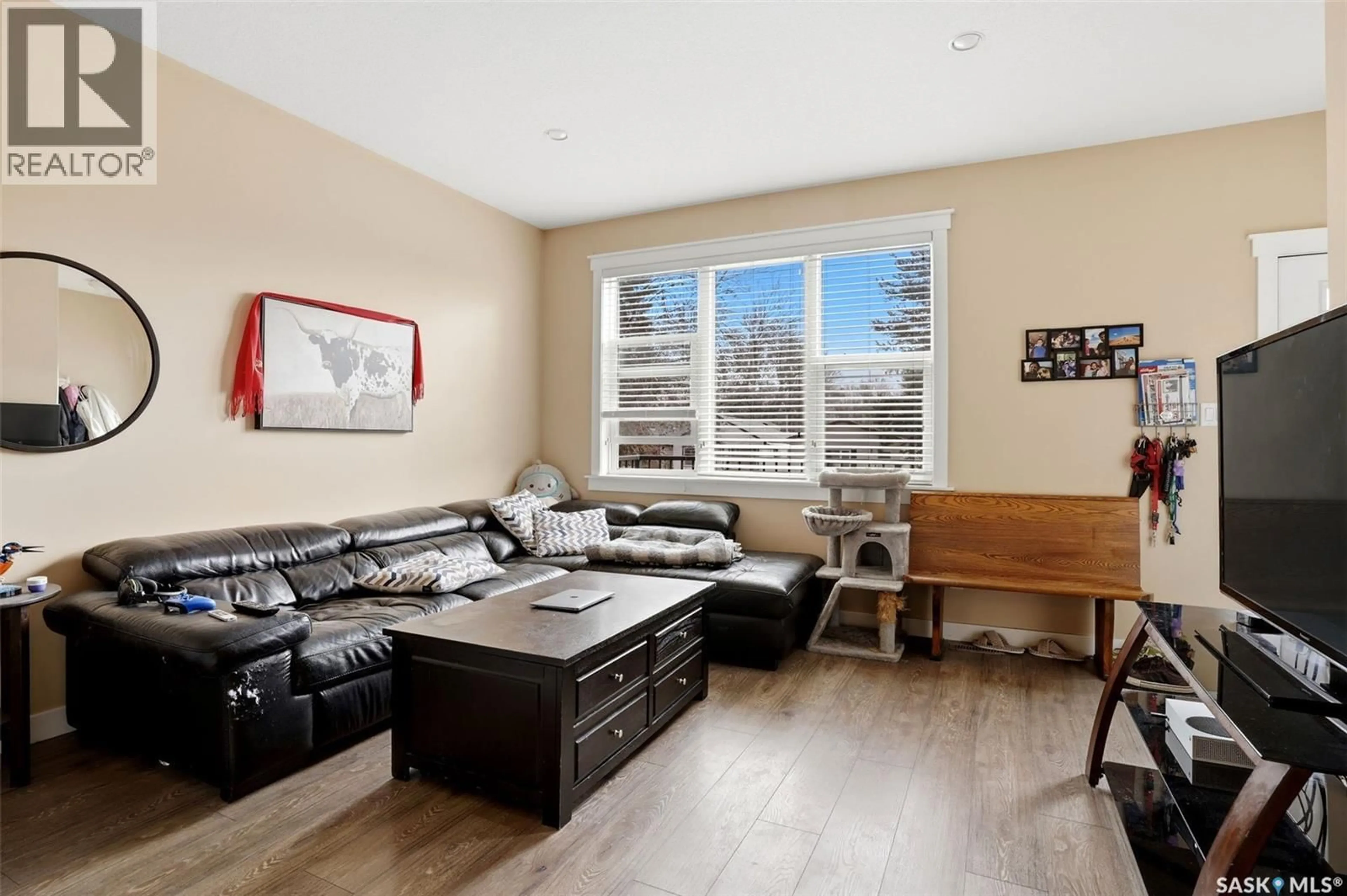 Living room with furniture, wood/laminate floor for 2542 MCDONALD STREET, Regina Saskatchewan S4N2Z5