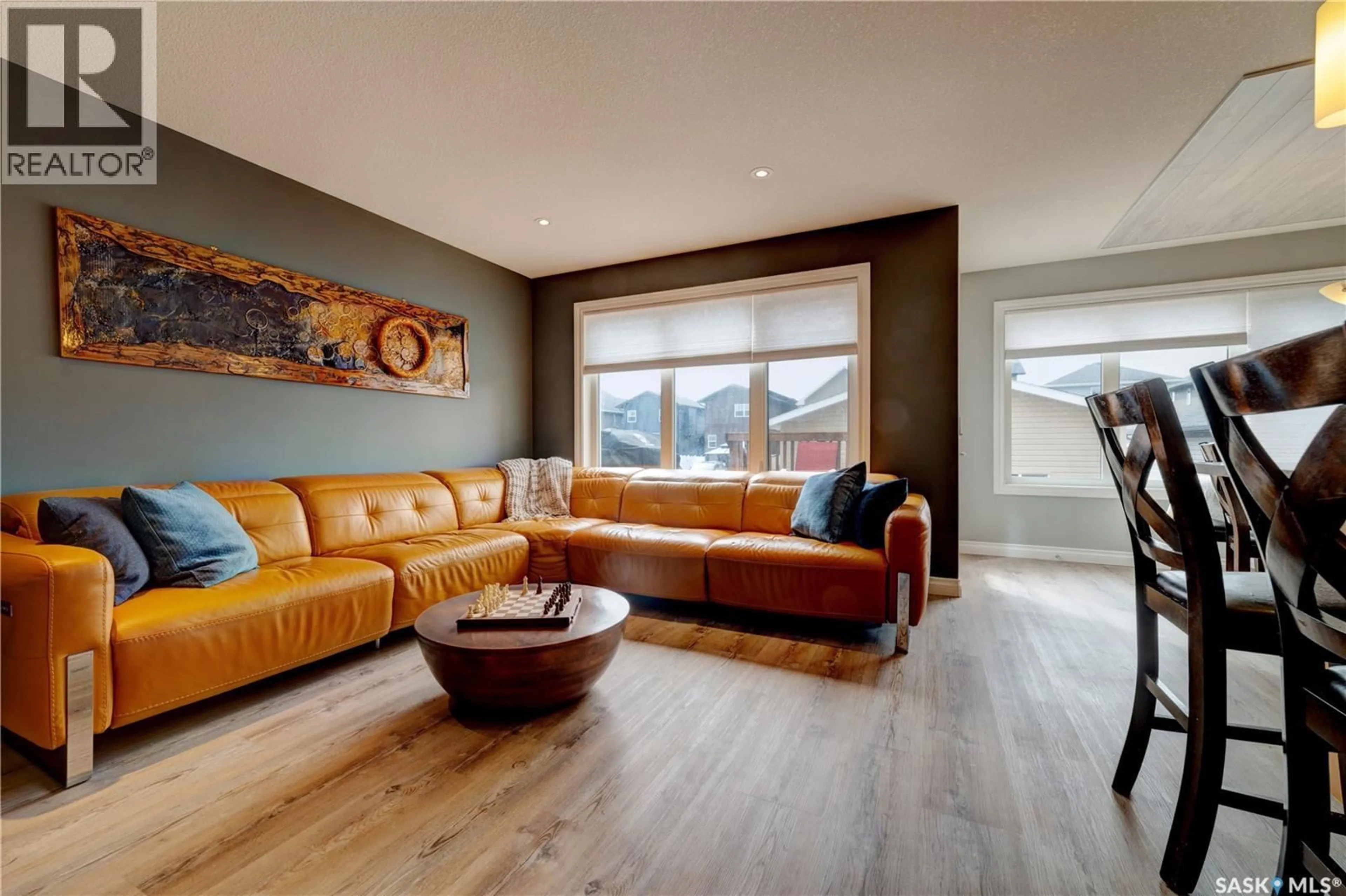 Living room with furniture, wood/laminate floor for 8717 ARCHER LANE, Regina Saskatchewan S4Y0B9