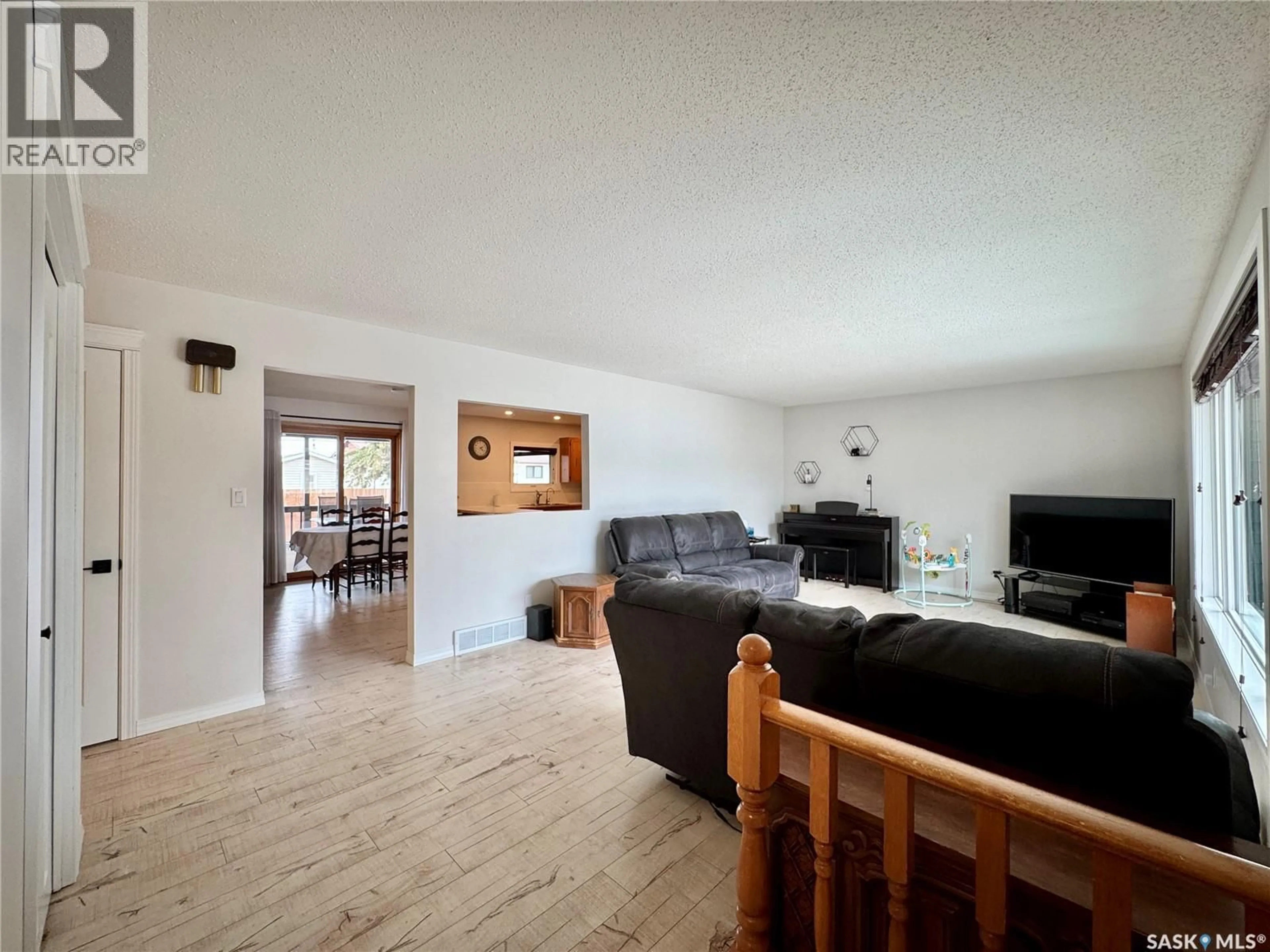 Living room with furniture, wood/laminate floor for 813 STANLEY STREET, Esterhazy Saskatchewan S0A0X0