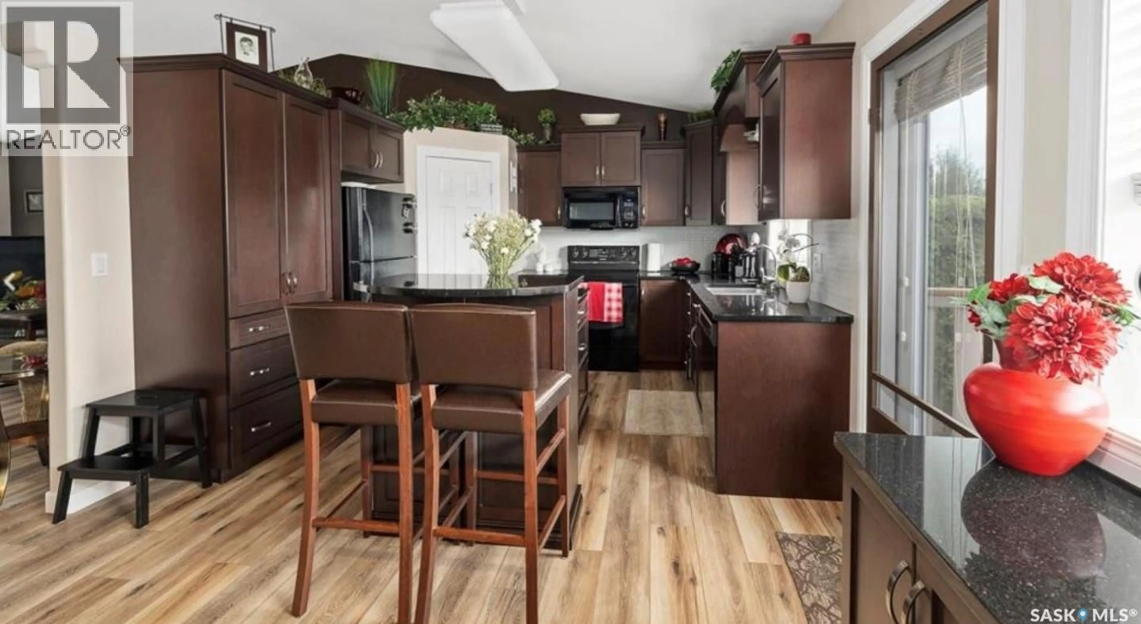 Open concept kitchen, wood/laminate floor for 671 FAIRBROTHER PLACE, Saskatoon Saskatchewan S7S1J2