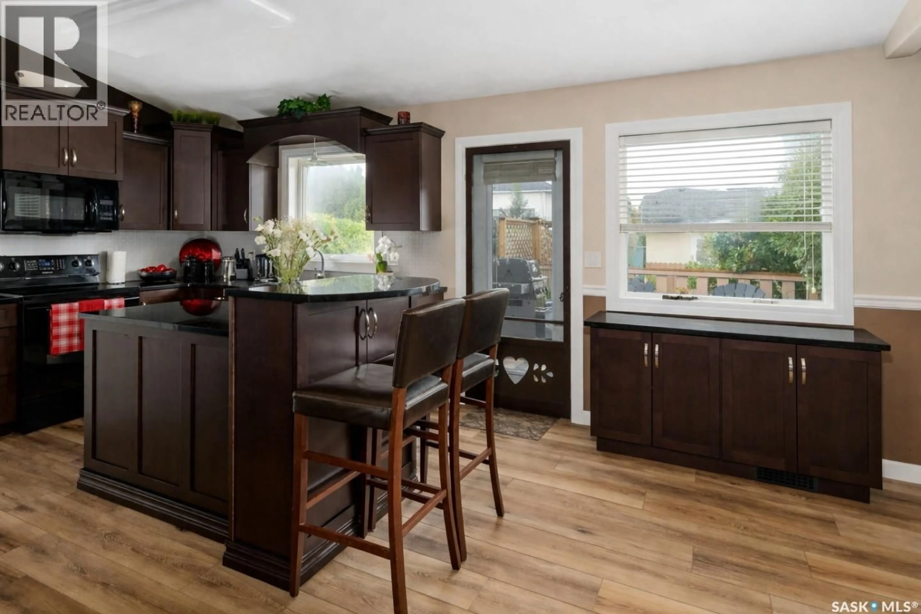 Open concept kitchen, wood/laminate floor for 671 FAIRBROTHER PLACE, Saskatoon Saskatchewan S7S1J2