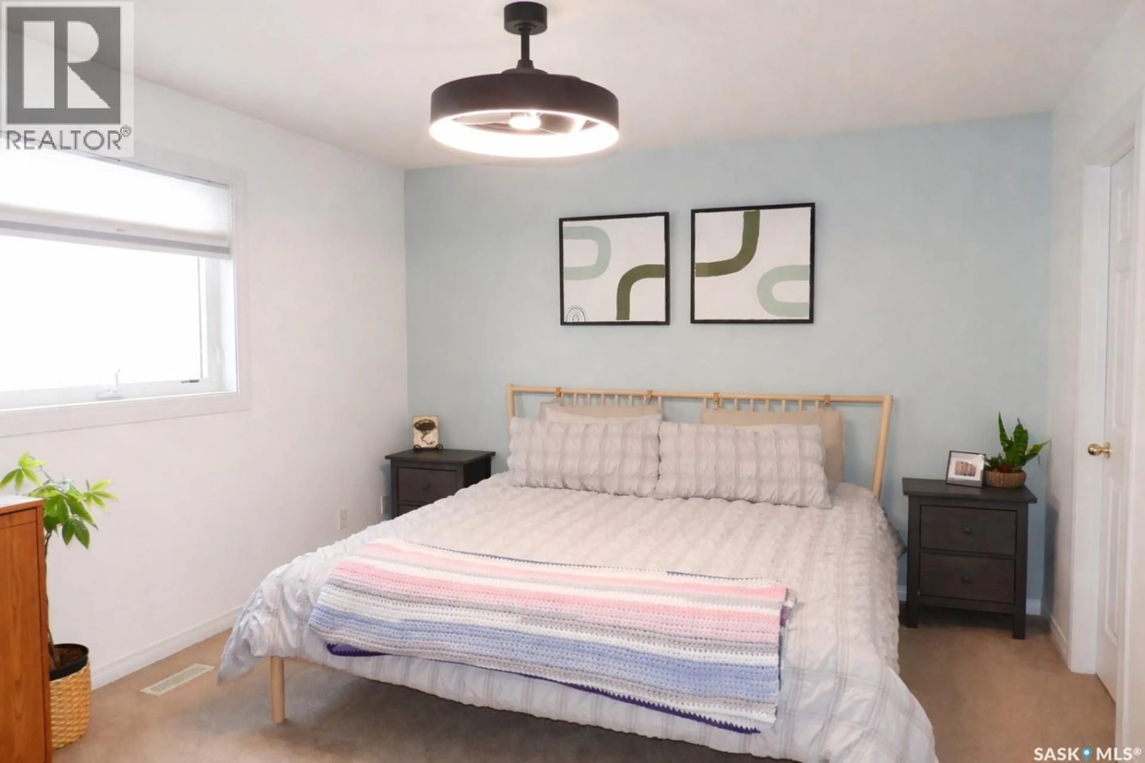Bedroom with bed, wood/laminate floor for 671 FAIRBROTHER PLACE, Saskatoon Saskatchewan S7S1J2