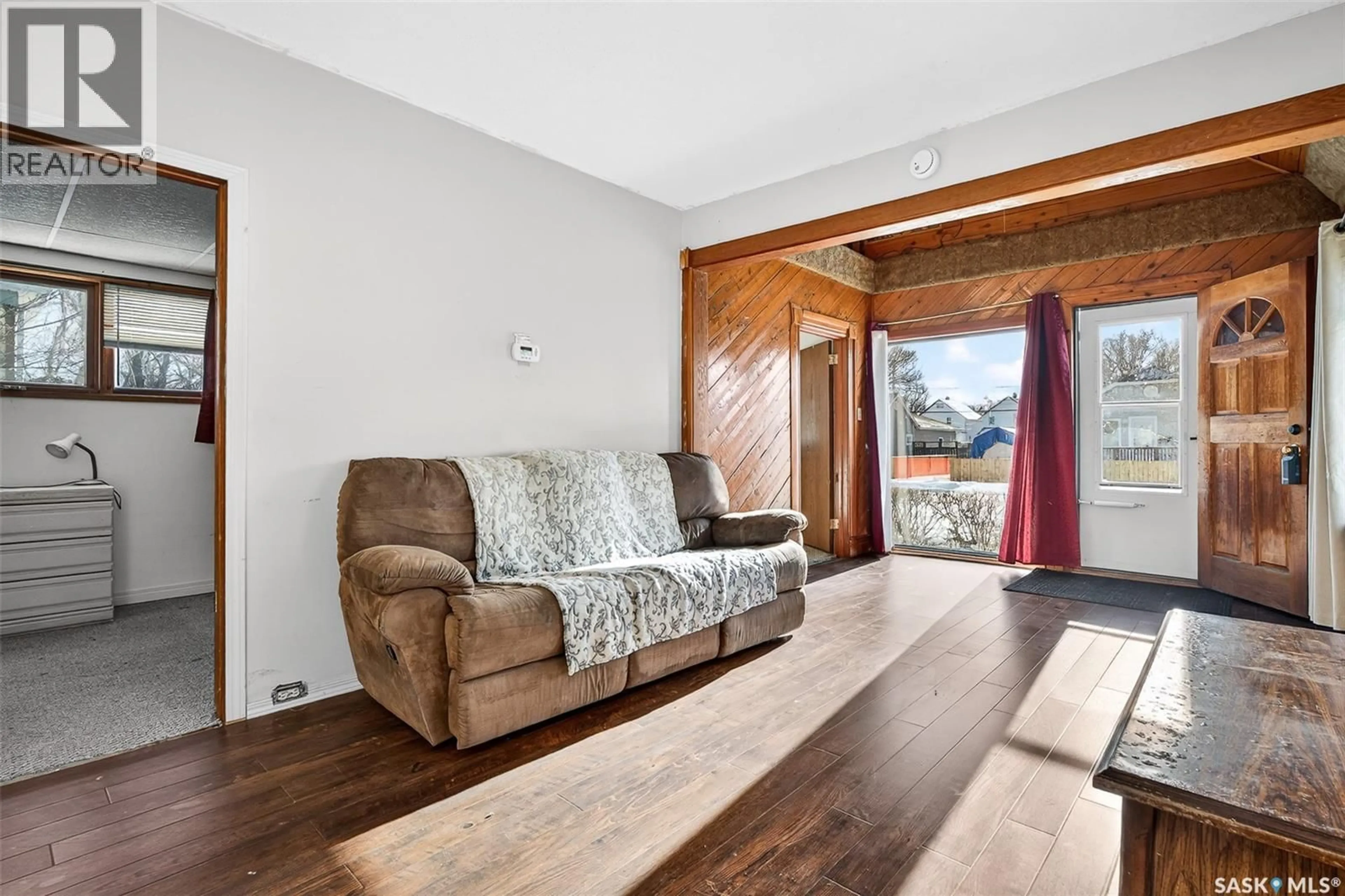Living room with furniture, wood/laminate floor for 528 OMINICA STREET E, Moose Jaw Saskatchewan S6H0H3