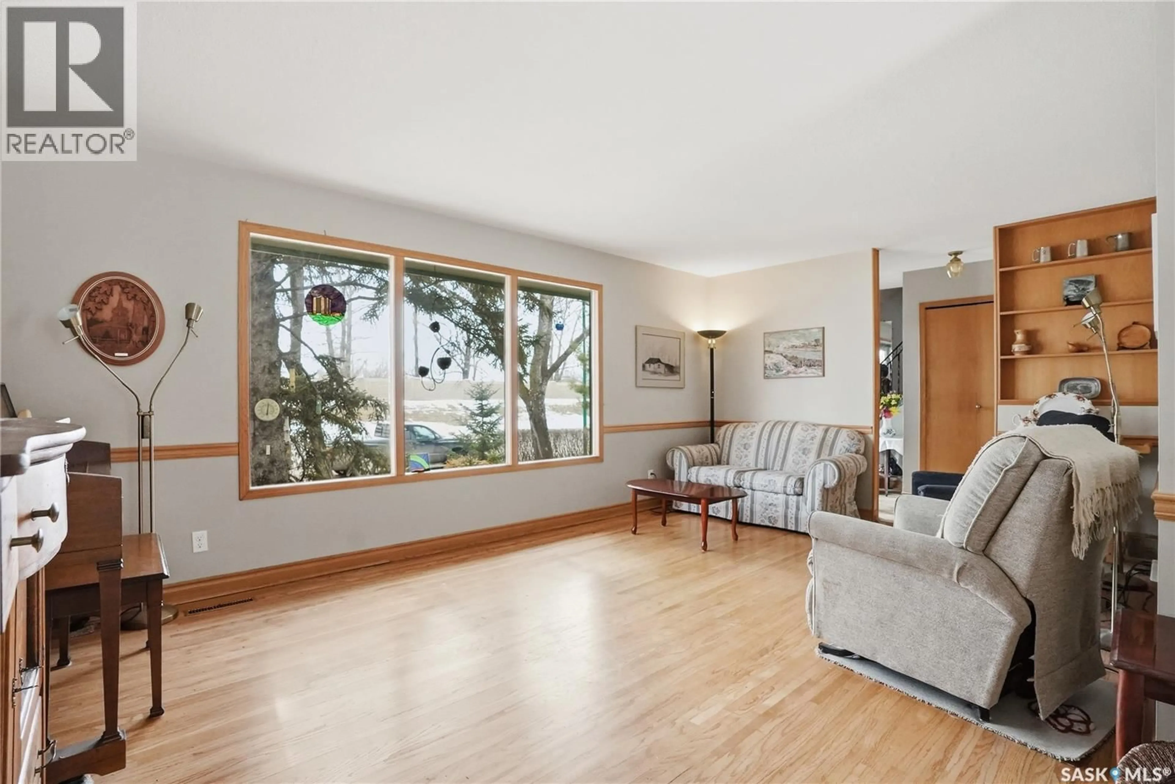 Living room with furniture, wood/laminate floor for 2338 EASTHILL, Saskatoon Saskatchewan S7J3E5