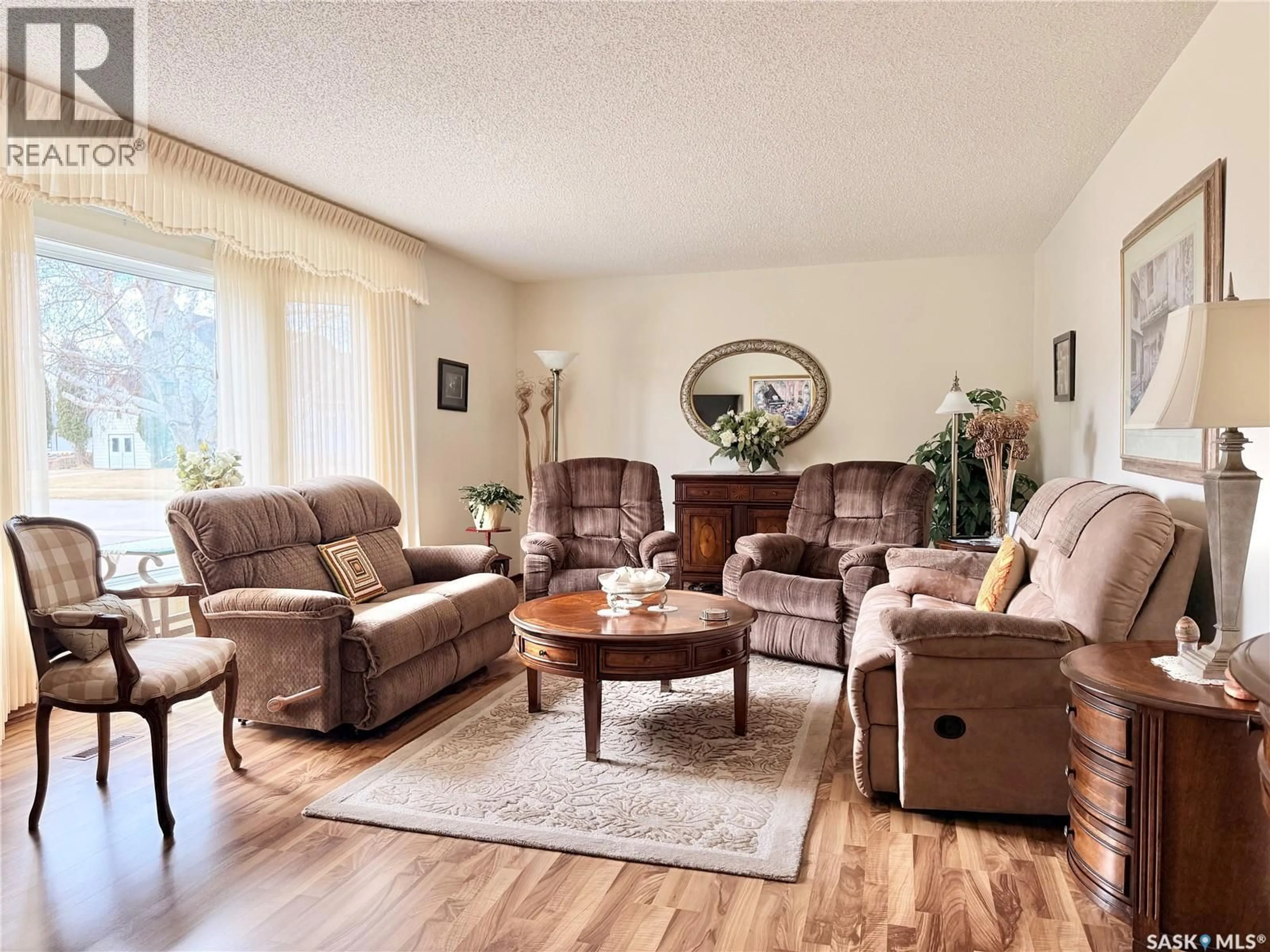 Living room with furniture, wood/laminate floor for 329 DOUGLASS STREET, Outlook Saskatchewan S0L2N0