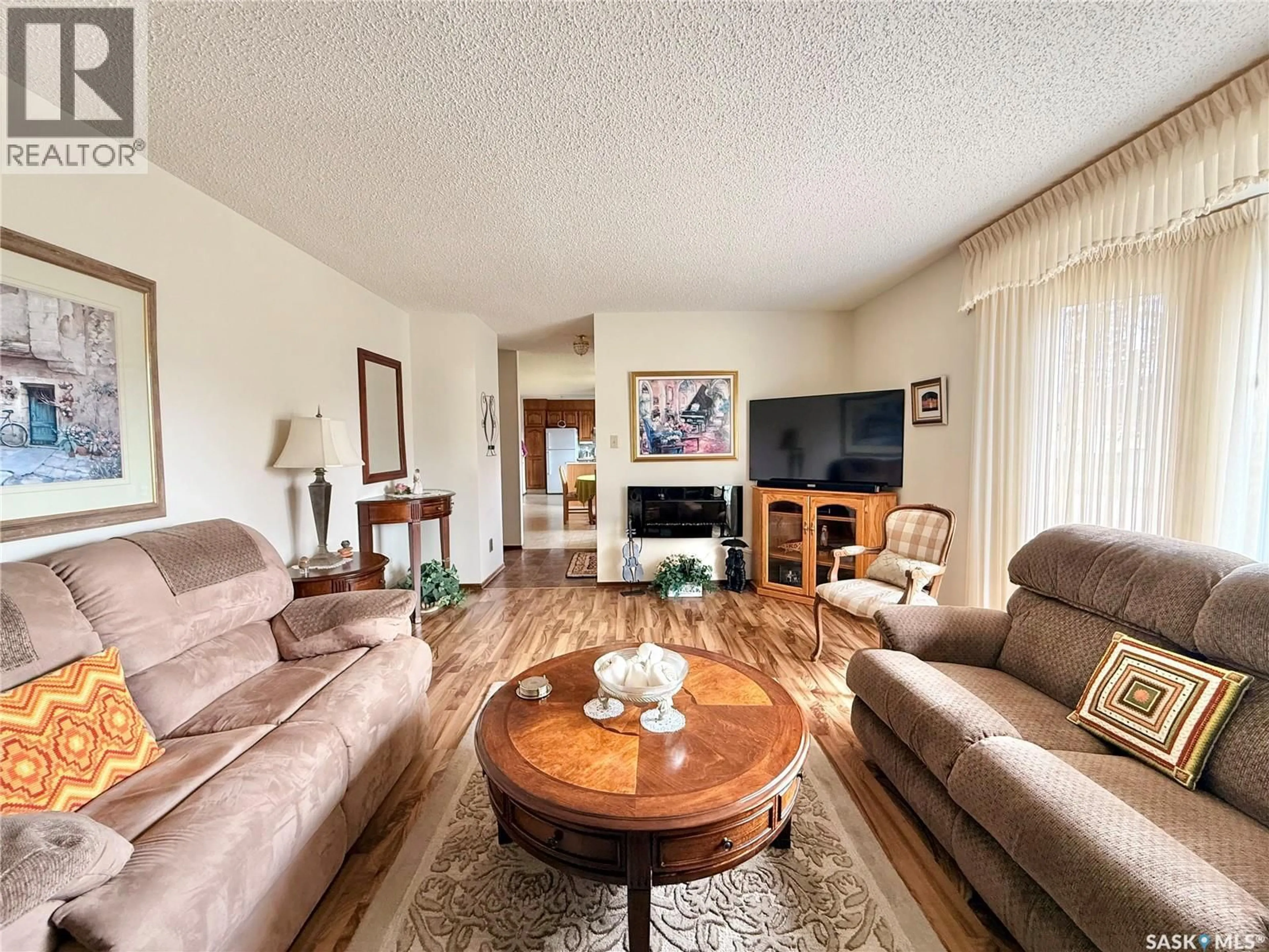 Living room with furniture, wood/laminate floor for 329 DOUGLASS STREET, Outlook Saskatchewan S0L2N0