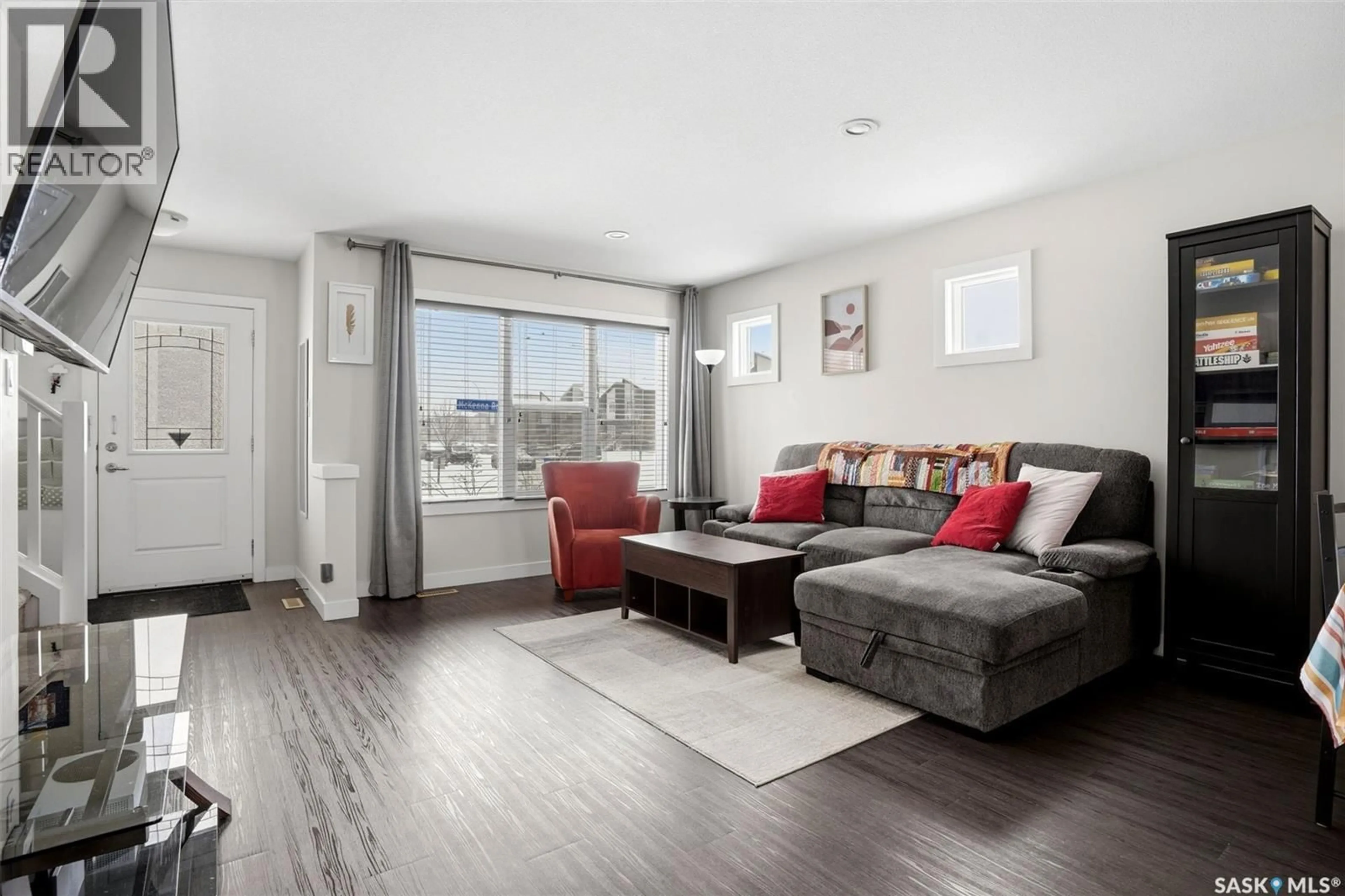 Living room with furniture, wood/laminate floor for 5500 MCKENNA ROAD, Regina Saskatchewan S4W0N7