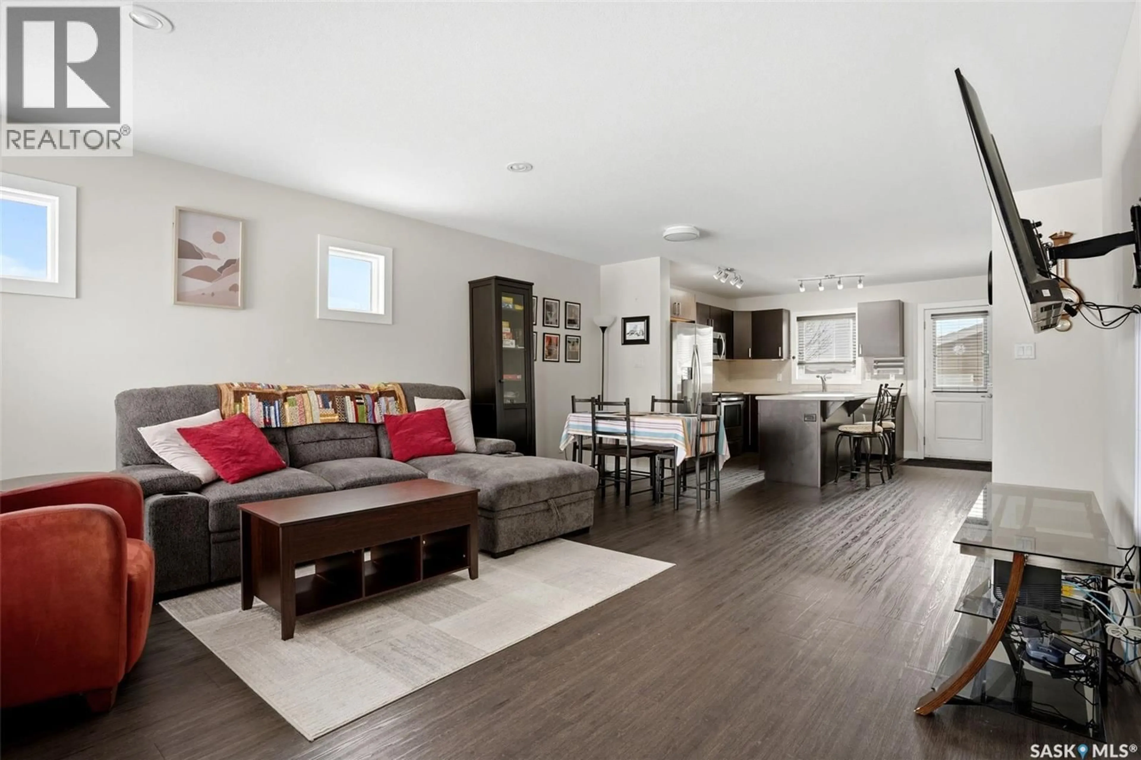 Living room with furniture, wood/laminate floor for 5500 MCKENNA ROAD, Regina Saskatchewan S4W0N7