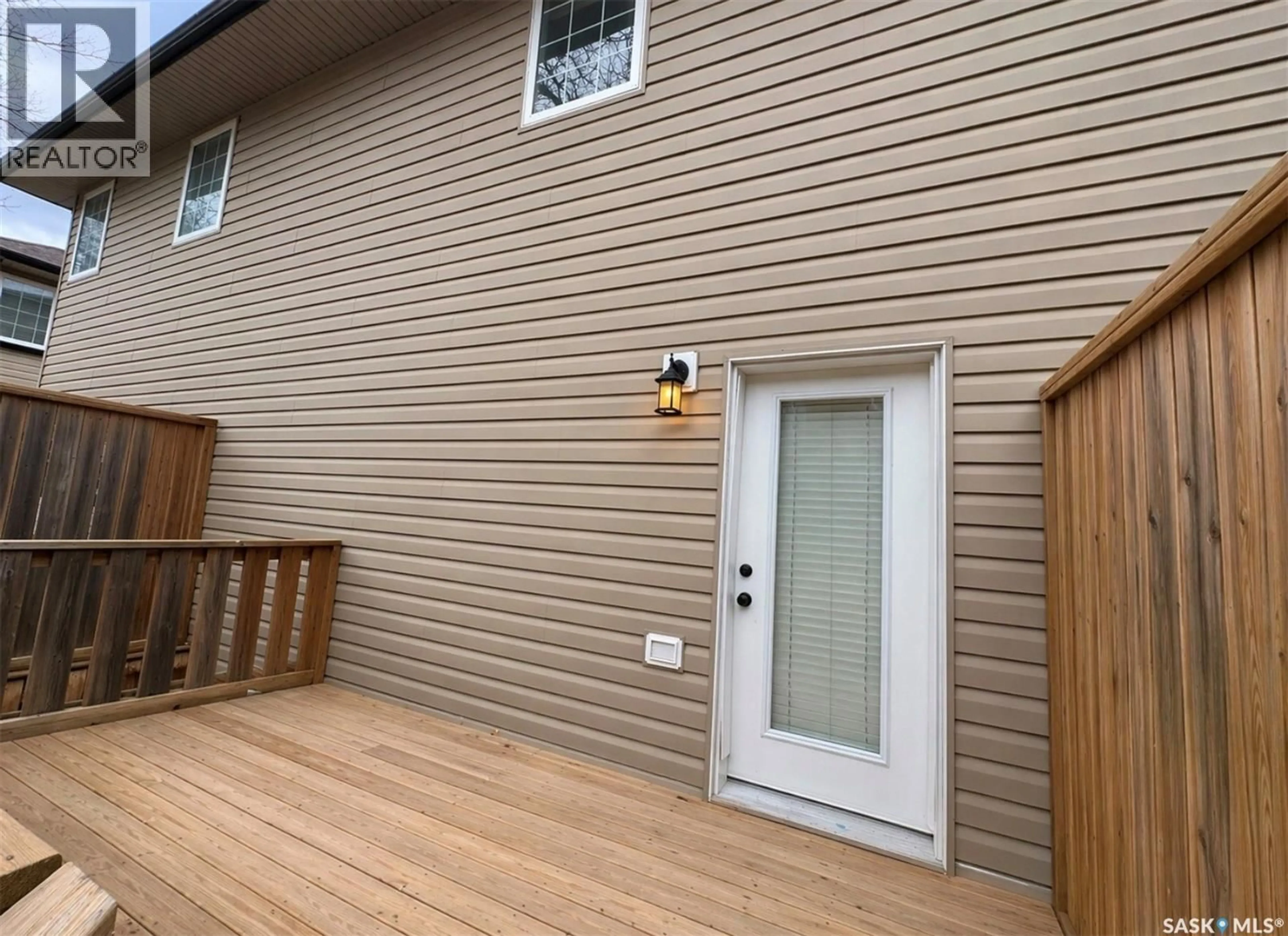 Home with vinyl exterior material, street for D2 - 33 WOOD LILY DRIVE, Moose Jaw Saskatchewan S6J1B4