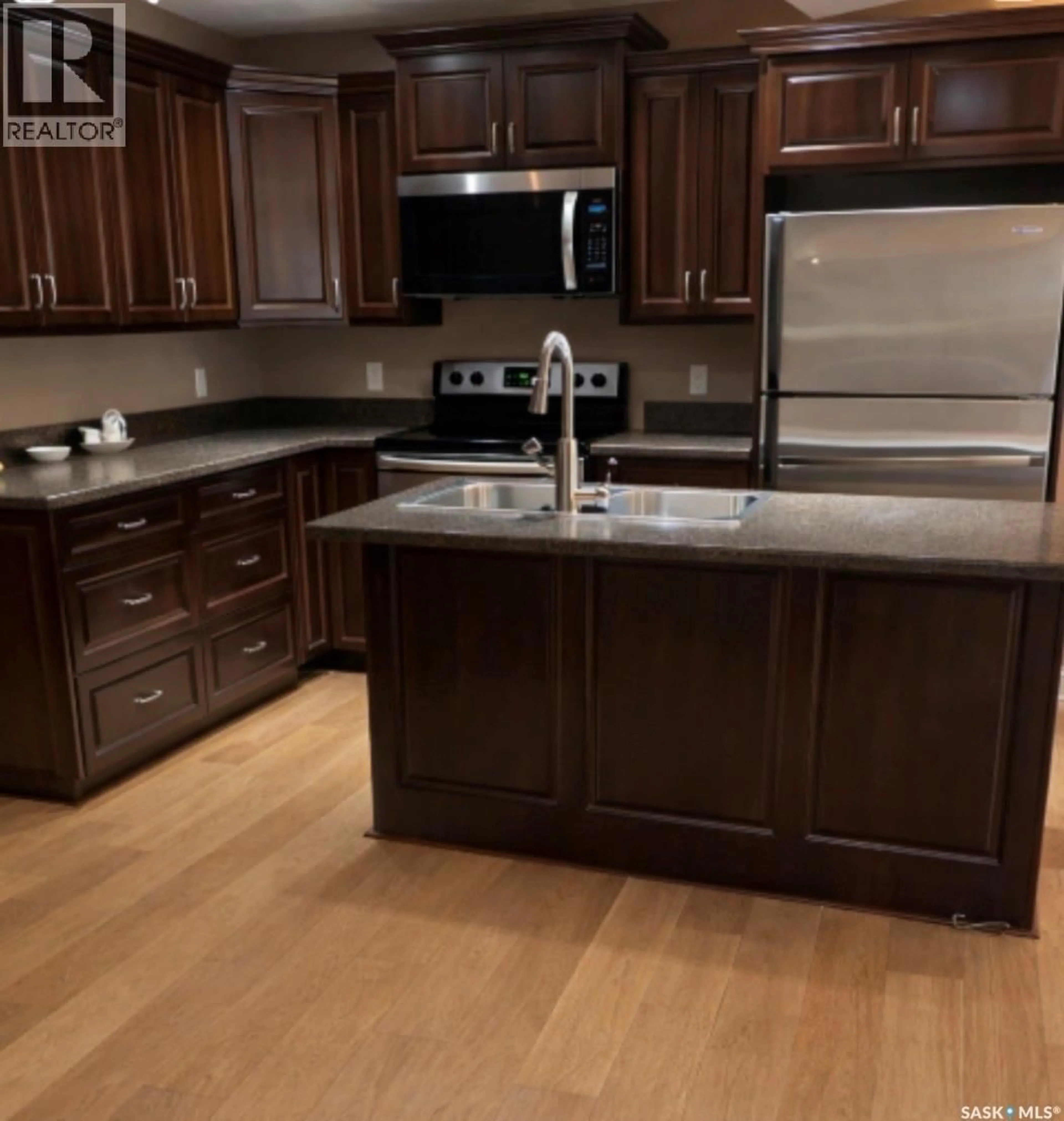 Open concept kitchen, wood/laminate floor for D2 - 33 WOOD LILY DRIVE, Moose Jaw Saskatchewan S6J1B4