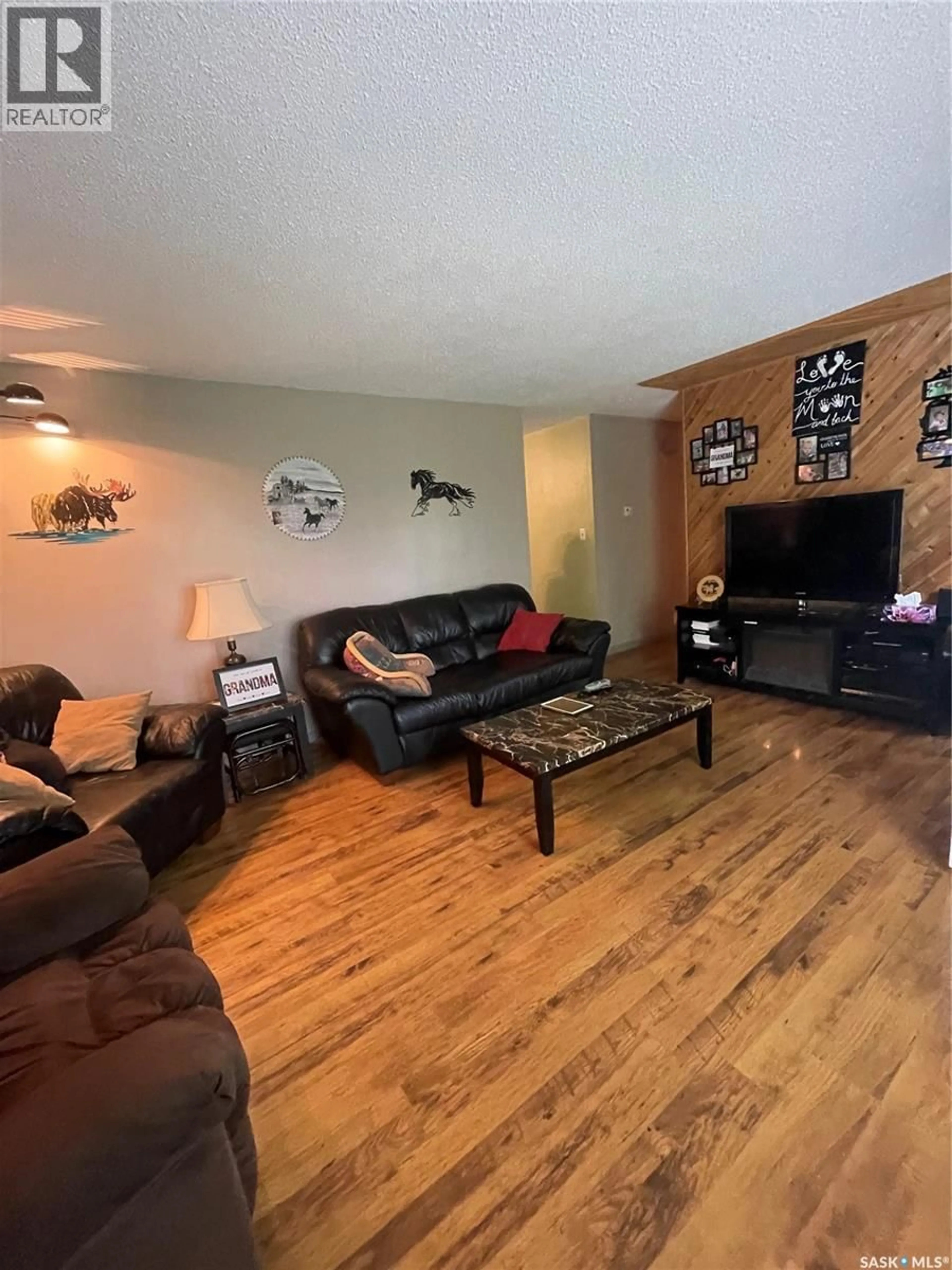 Living room with furniture, wood/laminate floor for 35 ACRES SOUTH HUDSON BAY, Hudson Bay Rm No. 394 Saskatchewan S0E0Y0