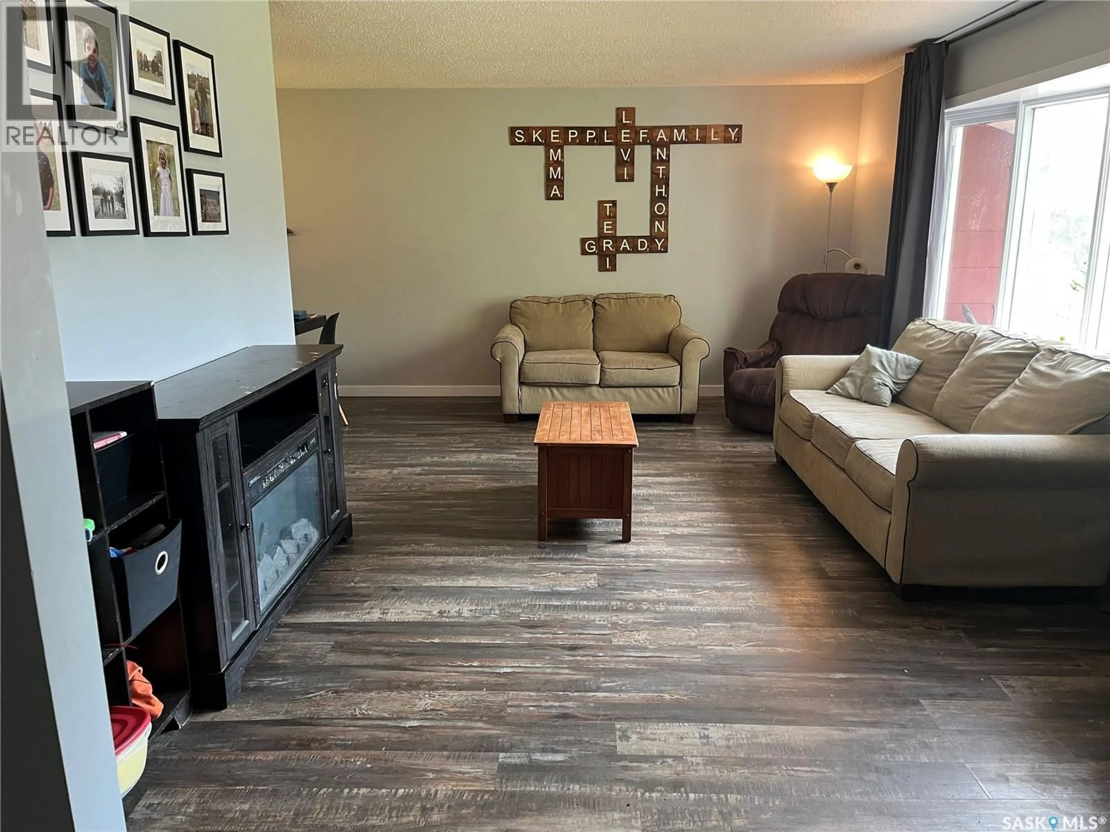 Living room with furniture, wood/laminate floor for 206 3RD AVENUE, Caronport Saskatchewan S0H0S0