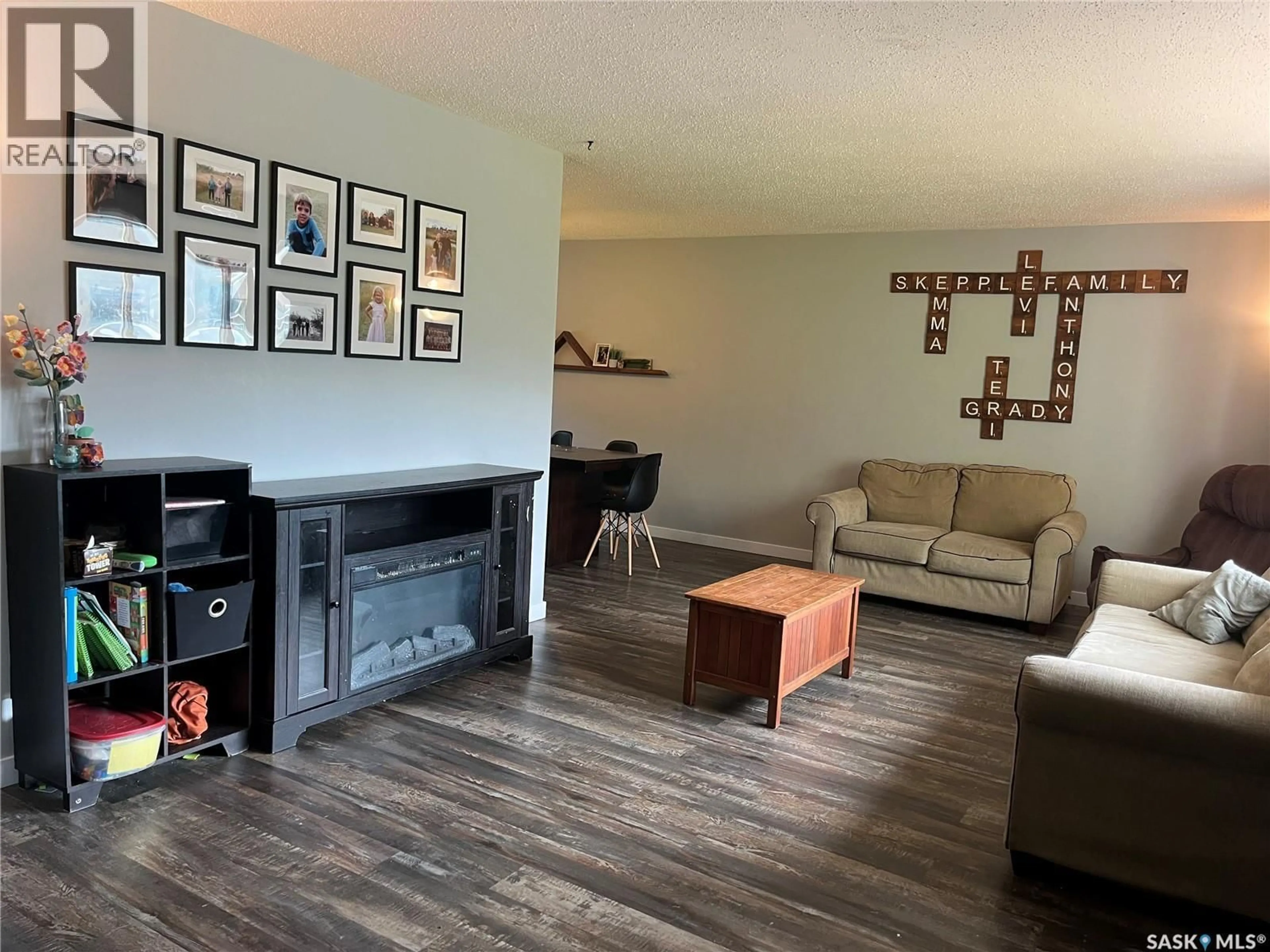 Living room with furniture, wood/laminate floor for 206 3RD AVENUE, Caronport Saskatchewan S0H0S0