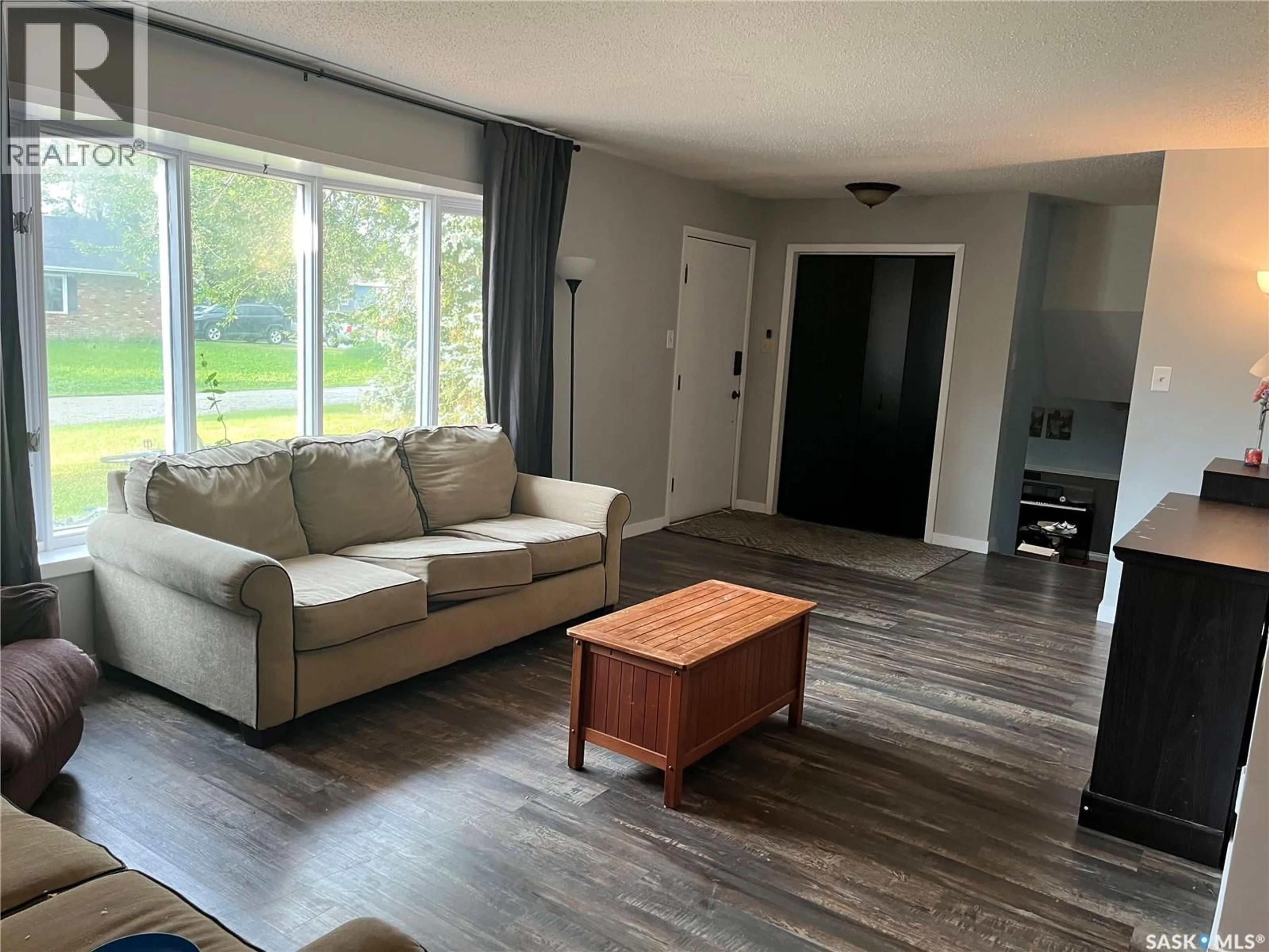 Living room with furniture, wood/laminate floor for 206 3RD AVENUE, Caronport Saskatchewan S0H0S0