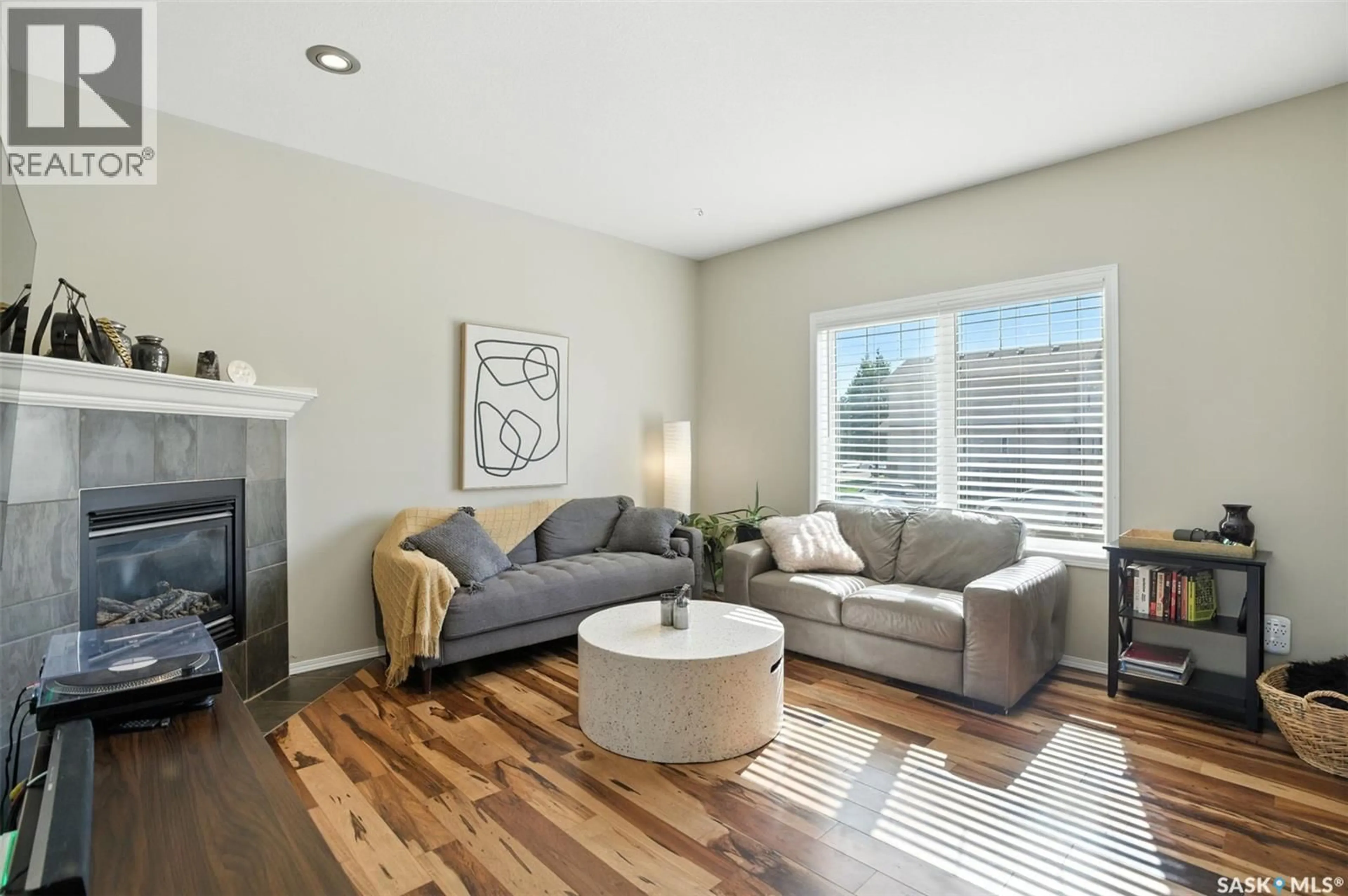 Living room with furniture, wood/laminate floor for 227 GALLOWAY ROAD, Saskatoon Saskatchewan S7T0B2