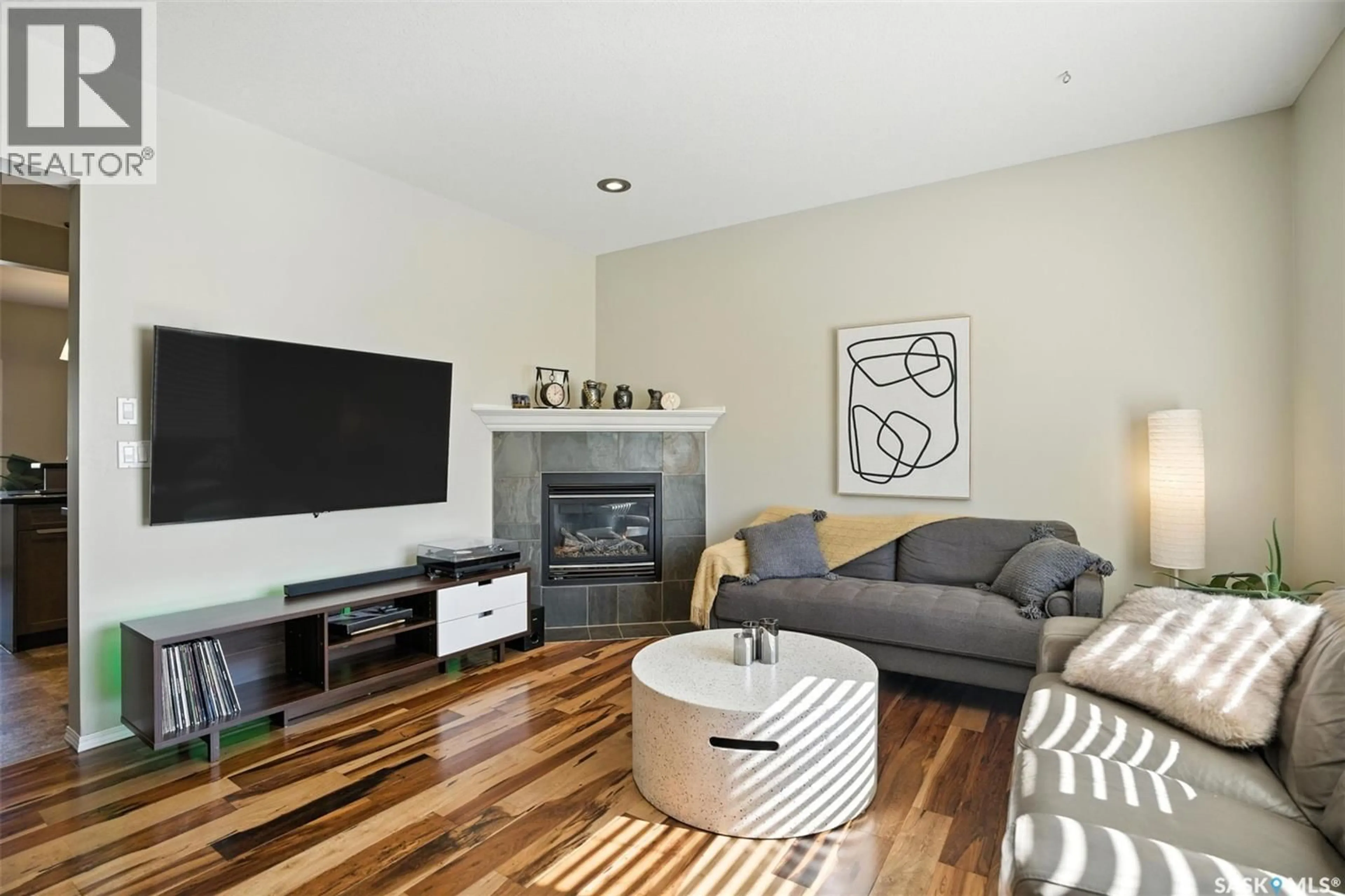 Living room with furniture, wood/laminate floor for 227 GALLOWAY ROAD, Saskatoon Saskatchewan S7T0B2