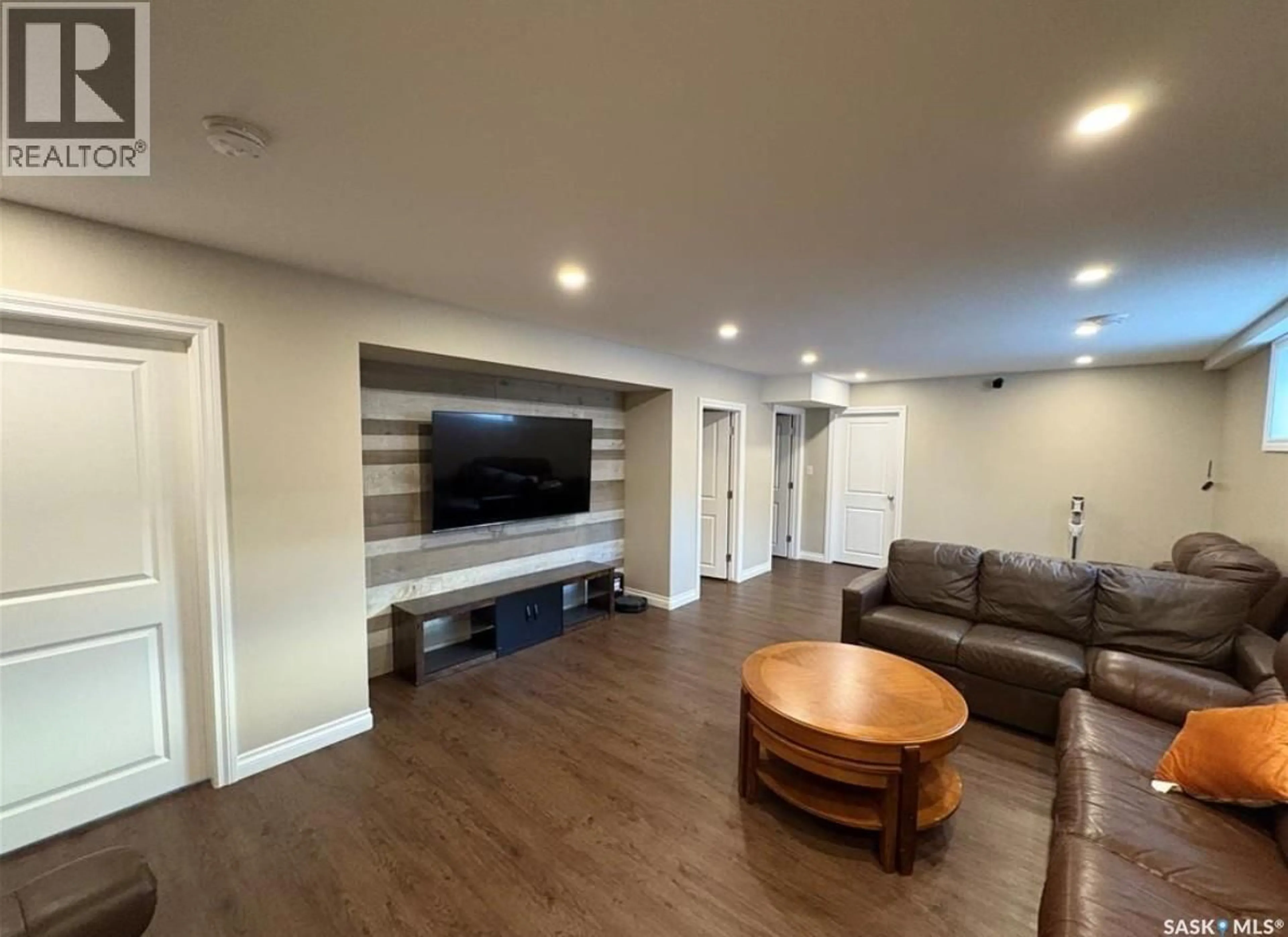 Living room with furniture, wood/laminate floor for 4301 GREEN POPLAR LANE, Regina Saskatchewan S4V1R1