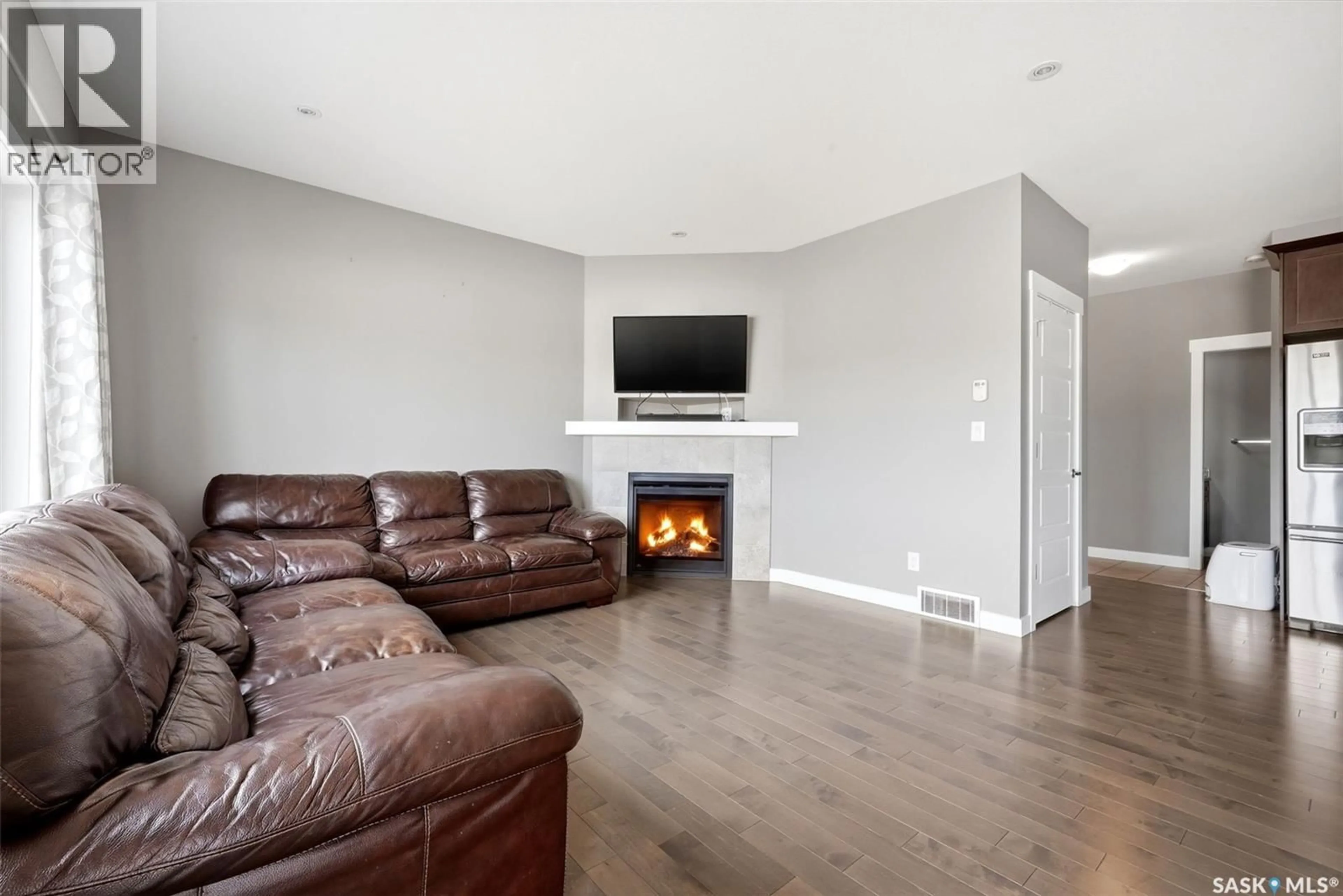 Living room with furniture, wood/laminate floor for 5517 NORSEMAN CRESCENT, Regina Saskatchewan S4W0J8